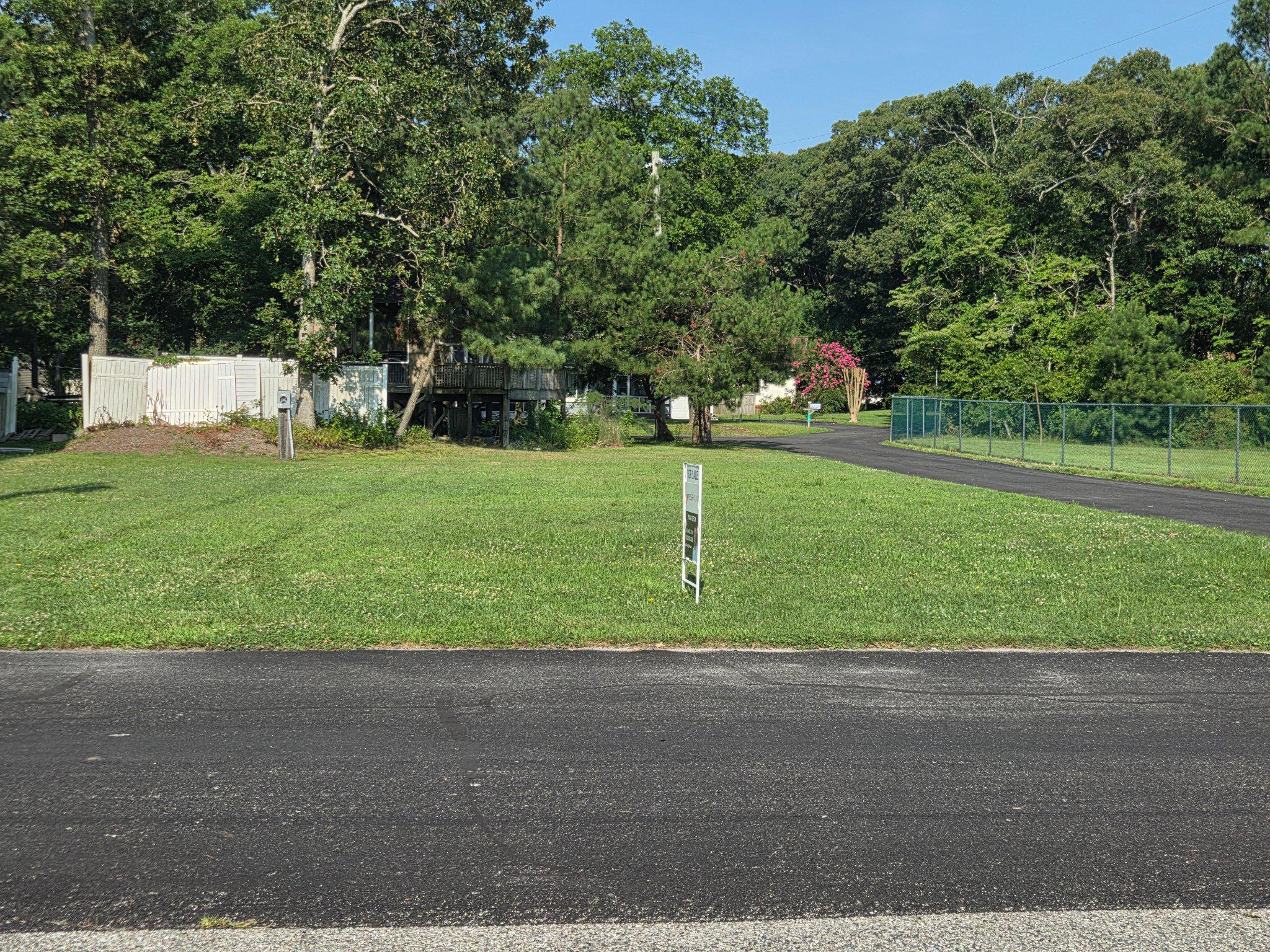 Discover this prime corner lot in the Dogwood Acres subdivision, offering a unique opportunity for your dream home. This property boasts stunning views of the Bay and Canal, perfect for those who appreciate serene living. Just steps from the community boat ramp and your own deeded boat slip you can enjoy the ease of waking up and being on the water in just minutes.  Situated on a corner lot, the correct building design will provide expansive and unobstructed views of the canal and Indian River Bay.  Imagine waking up to picturesque views and the gentle sounds of nature. This lot is ideal for buyers seeking a peaceful retreat while remaining close to local amenities. Embrace the potential of this lot and create the lifestyle you've always envisioned. Don't miss out on this exceptional opportunity to design and build your dream home overlooking the Bay!  Walking distance to access to a portion of the Piney Point Wildlife refuge and a pristine quiet beach that is perfect for wading, SUPs or kayak launching.  Vines Creek Marina is also just around the corner for your boating needs.