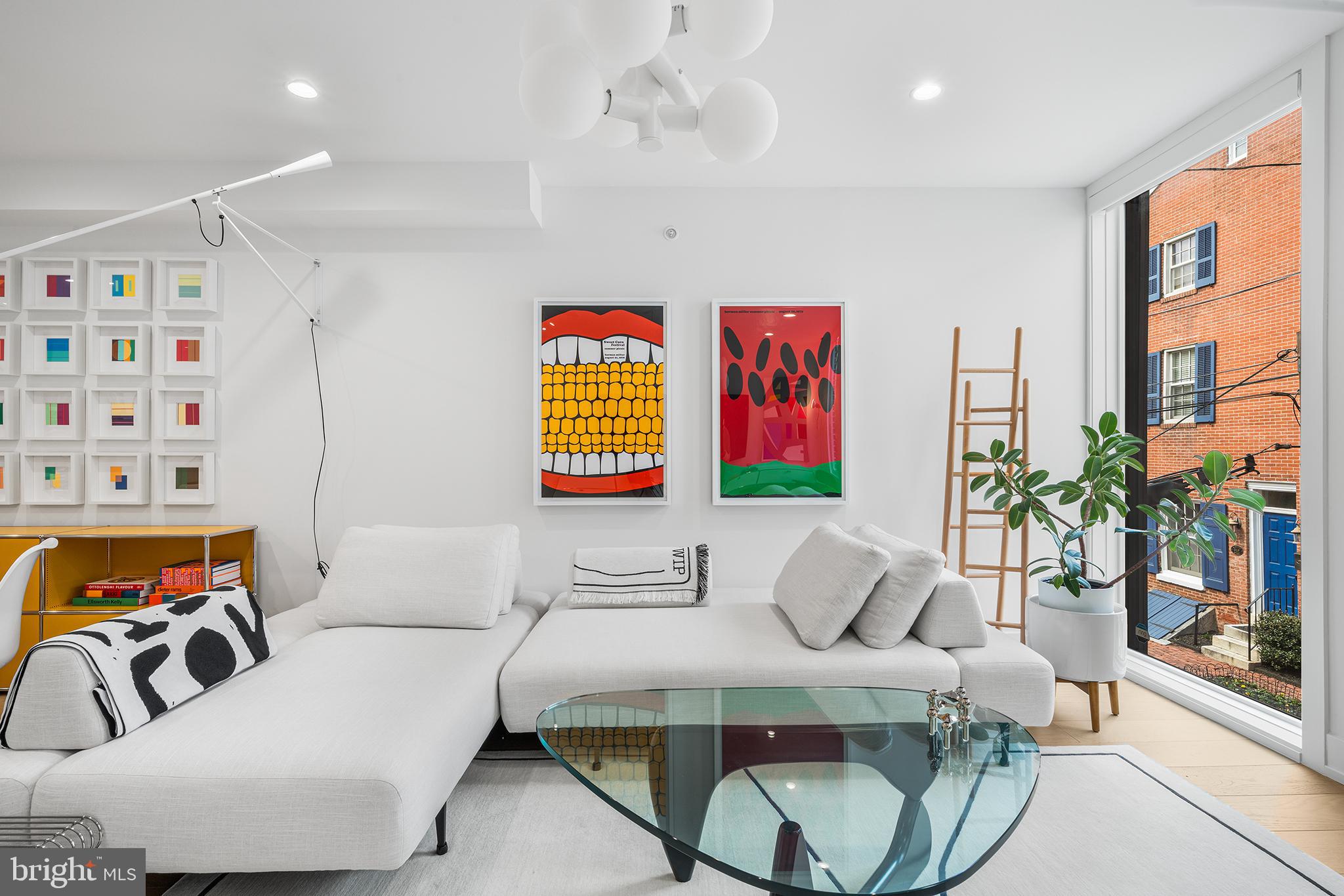 A rare residence, imagined in 2021 by the award-wining architect, Gnomes, in highly sought-after Washington Square West, is a true modern urban gem.

Refined interiors and oversized windows create a museum-quality sensibility with a perfect blend of character and elevated lifestyle. Every detail in this home is thoughtfully designed. Natural light streams across the wide plank white oak floors throughout the house. Three private outdoor living spaces, an attached garage with indoor access, home gym, and a separate laundry room, are all rare finds in a Center City home.

Garden Floor: A custom designed security front door gate leads you to a brightly lit lounging area that can also serve as an office with glass sliding doors leading to a private urban garden. This floor also has a half bath.
Basement: Home gym and storage.

First Floor: A dramatic entertaining level with a high floor-to-ceiling window with custom automatic solar shades throughout. An oversized gallery wall ideal for large-scale art offer both privacy and architectural beauty. The sleek, modern kitchen is a chef’s dream, boasting Bertazzoni appliances, quartz countertops, and a built-in fridge. Adjoining the kitchen, a glass door leads to a private balcony overlooking the garden, perfect for morning coffee.

Second Floor: Two spacious brightly-lit bedrooms, a full laundry room, and a sleek bathroom with black fixtures.
Third Floor: A tranquil primary suite greets with you with a Moooi Pendant light, oversized windows with breathtaking views of the city, walk-in custom California Closet in Luxe Dove, and automatic solar and blackout shades. The spa-like bath includes a double vanity, soaking tub, and two dual shower systems. Down the hall, grab a drink from the wet bar beverage fridge and head to the roof deck for an unbelievable 360 view of the city, enjoy evening cocktails, or simply unwind after a long day.

Situated on one of the most coveted blocks on a tree lined street, moments from Rittenhouse Square and Segar Park, this home offers both serenity and city access. Whether you’re strolling to your favorite coffee shop, sampling a new restaurant, or exploring Philadelphia's rich history, this address puts you at the heart of it all.

The remaining 5 Year Full Tax Abatement does not hurt either!