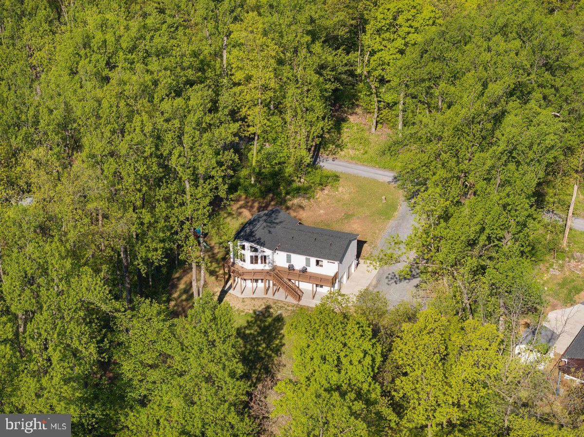 Better than new construction! Plus 5% assumable VA loan$$ Tucked away in a peaceful, secluded setting, this open, bright, and serene 4-bedroom, 3-bath home is surrounded by stunning mountain and tree-lined views, offering the perfect blend of privacy and natural beauty—just a short drive to Shenandoah National Park, Main Street, and The Inn at Little Washington. The upper level features a spacious primary suite with private bath, along with two additional bedrooms and a full hall bath, while the walk-out basement includes a fourth bedroom and full bath—ideal for guests or flexible living.

The heart of the home is the light-filled living area, where large rear-facing windows perfectly frame the breathtaking mountain and wooded views. Enjoy relaxing or entertaining on the back deck, soaking in the peaceful surroundings and vibrant seasonal changes—especially in the fall when the foliage is at its peak. The walk-out basement provides convenient access to the garage and backyard space.

Located in a quiet, friendly community with no formal HOA, residents enjoy access to private lakes and a boat landing, adding to the outdoor lifestyle this property offers. With its combination of scenic beauty, privacy, and convenience, this home is a true retreat while still being within reach of town amenities.
Interior photos coming 5/27