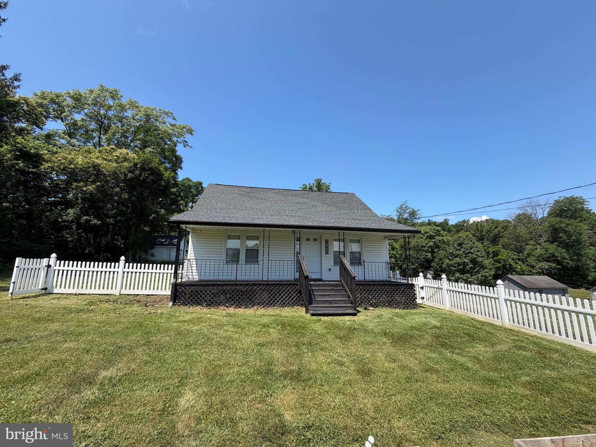One of a kind, ready to move in cape cod sitting on 4.78 unrestricted land.  This 3 bedrooms 2.5 bath home has been renovated in 2021.  Large open family room has vaulted ceiling with lots of natural light, ceiling fan and recess lighting. Luxury plank floors throughout the main level. Open concept flows from family room to the open kitchen with corian countertops, Bosch & Whirlpool stainless steel appliances, extra seating and cabinets at the kitchen island, dual deep sinks, walk in pantry.  Move into the living room with designer wall paper and TV hook up. Master Bedroom is on the main level, has it own en suite, with large shower/tub, vanity with storage and extra cabinets.  Walk in closet. 
Walk up the hardwood designer stairs to the upper level where there are 2 more bedrooms and a full bath. Each with ceiling fans and extra ac.   Custom paint and wall paper throughout add the special touch,  Laundry is on the main level- upgraded Samsung Bespoke all in one washer/dryer combo does all you laundry needs. Basement has room for storage, shelves, plumbing improvements, water quality improvements installed a 3-stage water purification system and water softener, and an extra tall freezer.  Enjoy your mornings on the front porch over looking the front yard with a white picket fence and 6 garden beds or enjoy your evening grilling out on the large back deck facing 
your acres.  1 car detached garage, newly paved driveway.  This property may be able to offer an assumable VA loan