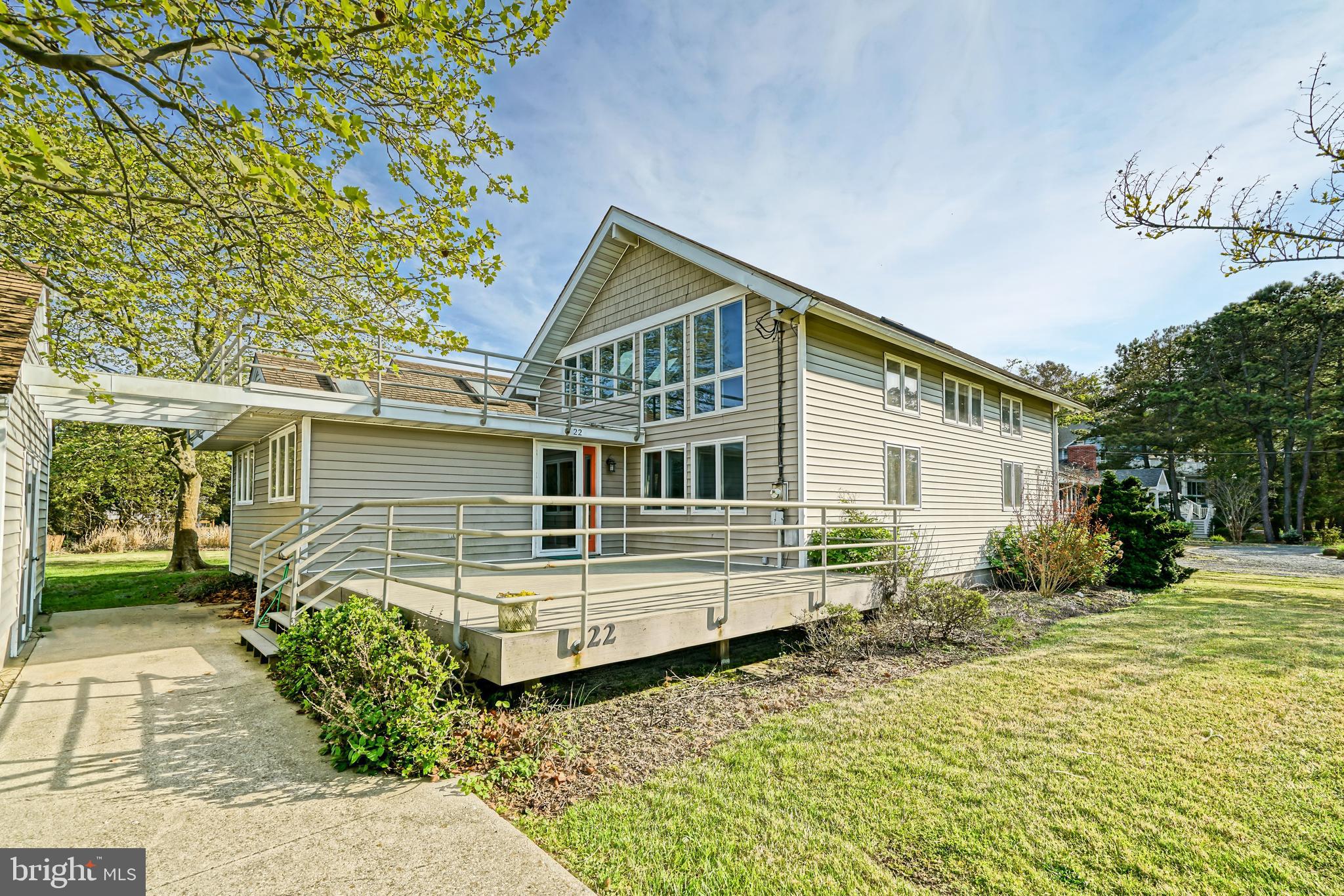 LOCATION, LOCATION, VACATION! Make every day a vacation in this classically coastal beach home located just a seashell’s throw from the Lewes Rehoboth Canal and only a block from the beach in North Shores! This inviting property features 4 bedrooms, 2.5 baths, and spacious living areas accentuated by vaulted ceilings, classic Mexican tile flooring, and that quintessential beach-life feeling!  Situated on a generously sized 0.34 acre lot, it boasts expansive yards and decks, excellent for entertaining or unwinding. The open-air pergola attaches the main house to the bonus storage building with outdoor shower, perfect for storing all your beach, gardening, & biking gear. Ideal as a primary home, seasonal home, or rental investment with proven rental income averaging $75,000 annually! North Shores isn't just about beach access; it also offers security, outdoor community pool, tennis courts, boat launch, and more. You're also just minutes away from the Junction Breakwater Trail, Gordon's Pond State Park, and the vibrant Rehoboth Beach boardwalk. Seize this exceptional opportunity to reside in this much coveted community!