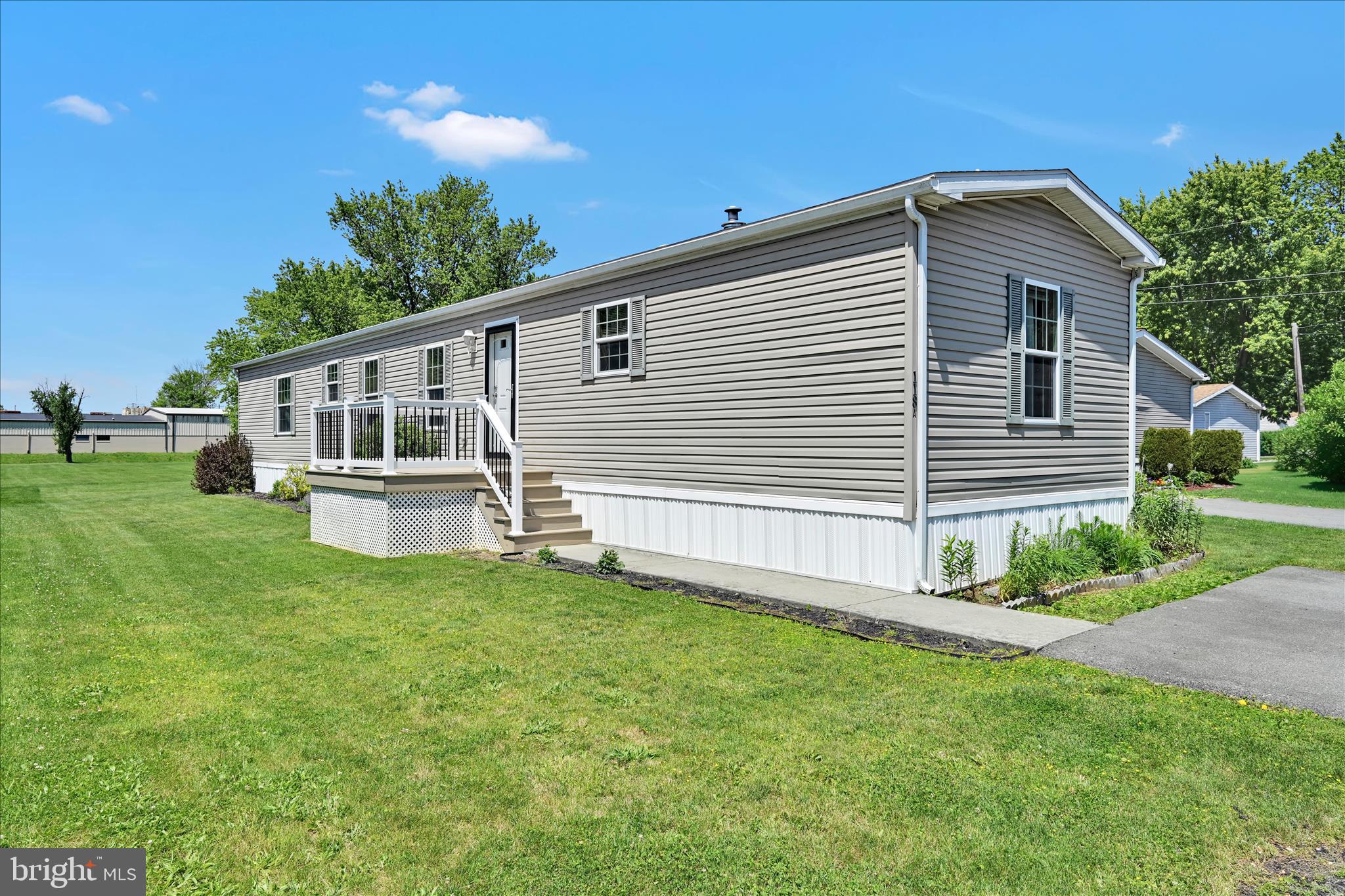 Charming and well-maintained, this single-wide mobile home is in a peaceful 55+ community — move-in ready and thoughtfully cared for. From the new deck at the front door, step into the bright, open Living Area with neutral décor, which flows into a lovely, efficient Kitchen with abundant cabinet storage. The adjacent Laundry Room provides ease and convenience with a little more storage space. 
The comfortable primary bedroom features a full bath and walk-in closet. Two additional bedrooms and another full bath complete the home.
Outside is a tidy storage shed which provides convenient outdoor space and storage. Located on a quiet street within a friendly, age-restricted community, you will find well-kept lawns and common areas and easy parking. Convenient to nearby shopping and medical services — ideal for downsizing or relaxed, independent living.