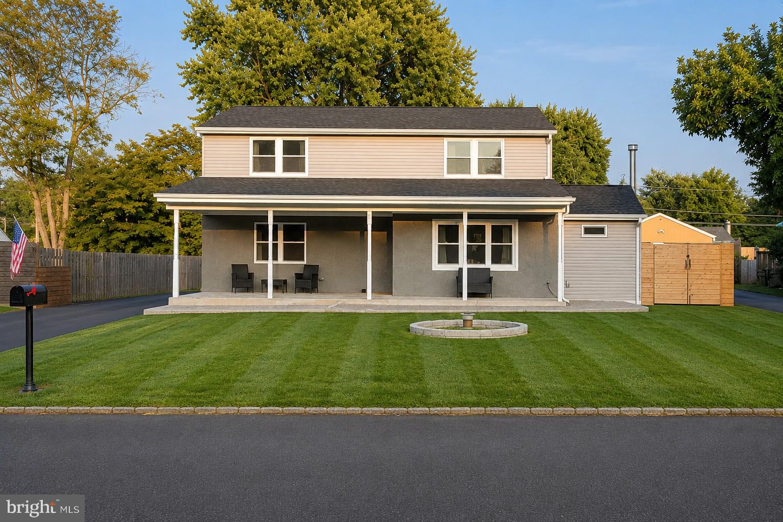 Completely renovated down to the studs in 2020, this stunning 4-bedroom, 2.5-bath home combines the charm of an established neighborhood with the peace of mind of modern construction.

A welcoming covered front porch leads into a spacious foyer, setting the tone for the thoughtfully designed interior. To the left, a comfortable family room provides the perfect place to unwind, while the open-concept kitchen and dining area create the ideal space for everyday living and entertaining. The beautifully updated kitchen features granite countertops, soft-close cabinetry, stainless steel appliances, and an oversized island with plenty of prep space. Just beyond, an inviting bonus living room with a wood-burning stove offers a warm and cozy gathering place year-round.

Upstairs, you'll find four generously sized bedrooms, including a spacious primary suite with a private en-suite bath. Three additional bedrooms and a beautifully updated hall bath provide plenty of room for family, guests, or a home office.

The unfinished basement offers endless possibilities for future living space, a home gym, workshop, or abundant storage.

Outside is where this home truly shines. The backyard was designed for entertaining, featuring an expansive paver patio with custom seat walls surrounding a built-in fire pit—perfect for summer nights and fall gatherings. The fully fenced yard provides plenty of room for kids, pets, or outdoor games, while the oversized detached two-car garage offers exceptional storage, workshop space, or parking for car enthusiasts. Beautiful paver walkways, fresh landscaping, and a newly paved driveway complete the exterior.

With nearly every major component updated during the 2020 renovation, this is a truly move-in-ready home where all the hard work has already been done. Simply unpack and enjoy.