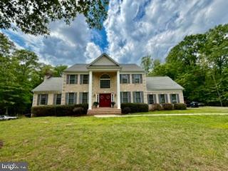 Stunning 4-Acre Colonial Estate with Endless Potential
Welcome to 1478 Spotswood Dr, an elegant 3,056-square-foot Colonial home nestled on a premium 4.02-acre lot in the highly desirable Governor Spotswood Estates neighborhood of Locust Grove, VA. Offering the perfect blend of classic architectural charm, open space, and modern capability, this private retreat is being sold as-is and presents a rare opportunity to customize your dream estate.

Key Property Features

Bedrooms: 3 spacious bedrooms on the upper level
Bathrooms: 2 full baths, 1 half bath
Square Footage: 3,056 finished sqft above grade
Lot Size: 4.02 private, wooded acres
Year Built: 2003
Impeccable Interior Craftsmanship
Step past the inviting red front door into a traditional three-story floor plan flooded with natural light, boasting 9’+ ceilings, elegant crown moldings, and classic chair railings. The main floor layout seamlessly balances formal spaces with cozy living area zones:
The Living Spaces: Features two masonry brick fireplaces—one equipped with cozy gas logs and the other a traditional wood-burning hearth, perfect for crisp Virginia autumns.

The Gourmet Kitchen: Designed for entertaining, featuring a functional kitchen island, built-in pantry, bright breakfast area, and recessed lighting.
Premium Flooring: A beautiful mix of solid hardwood, ceramic tile, brick accents, and  carpeting throughout.

Expansion Potential & Exterior Highlights
The exterior matches the grandeur of the interior, featuring a gray architectural shingle roof, outdoor landscape lighting, and a serene back porch  with white railings overlooking your massive yard.
Unfinished Walkout Basement: Features full-size daylight windows and doors that lead straight to the rear yard. Complete with rough-in plumbing for a full bathroom, this massive canvas is ready to be converted into an in-law suite, home theater, or recreation room.
Oversized 2-Car Garage: An attached, rear-facing garage featuring an extra-wide driveway and plenty of space for larger vehicles, workshop tools, or extra storage.

Enjoy the benefits of energy-efficient systems with dual central air conditioning and heat pumps, an owned propane system, underground utilities, and private well and septic infrastructure. Located in Orange County, this home offers peaceful privacy while remaining highly accessible to Route 3 for a smooth commute to Fredericksburg or Culpeper.