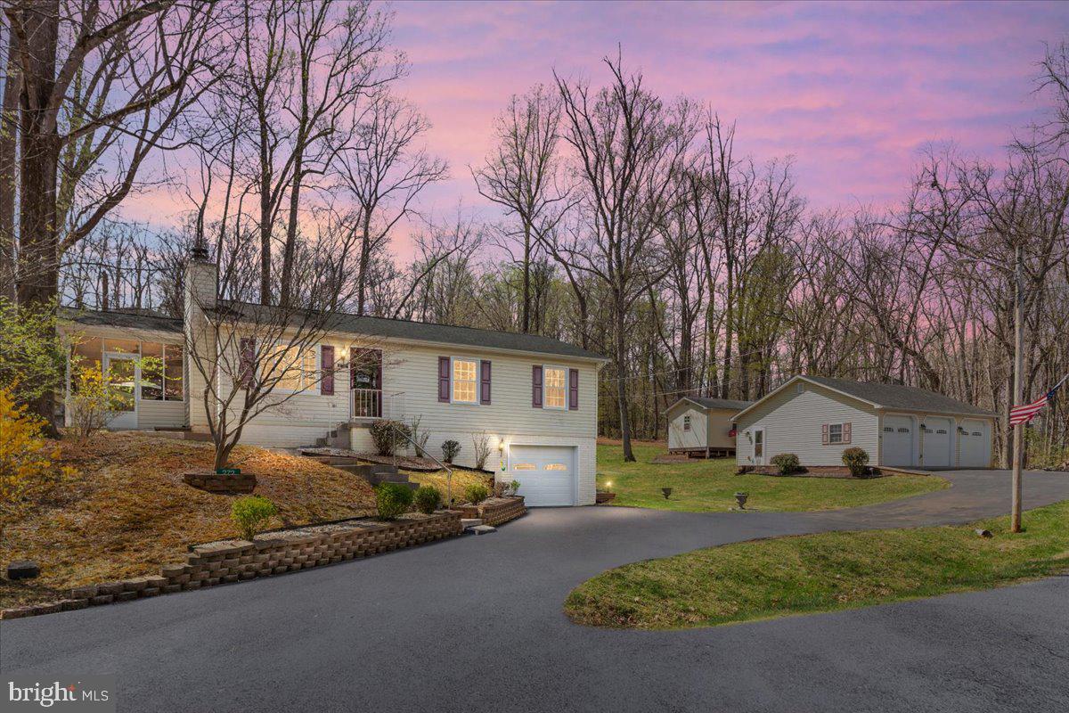 Welcome to this beautifully maintained home located in highly desired, Shenandoah Shores, one block from the Shenandoah River with community access and boat ramp.   Completely  updated, this home offers a perfect blend of modern amenities and country living, all while being conveniently close to town, I/66 and Christendom College. This home provides ample space for entertaining with a large screened porch, concrete patio, and hot tub. This home features 3 bedrooms, 2.5 bathrooms with a 1 car attached and giant 3 car detached garage.  A total of 1,700 square feet of living space with another 1,300 square feet of garage space. Almost everything has been updated in the last several years including the kitchen, bathrooms, flooring, HVAC, Windows and Roof. Situated on a large double lot of .62 acres, with a large and open yard. Enjoy the comfort of a heat pump for heating and central air conditioning for cooling with a cozy wood burning fireplace in the living room.  The detached garage is conditioned with a woodstove / window a/c.   The home also features a finished walkout basement with family room, office area and laundry room. A large storage shed with electricity rounds out the perfect property for those needing space for their toys/ hobbies. Shenandoah Shores is located in a Sanitary District is currently operated through the Shenandoah Shores Property Owners Association, Inc. (SSPOA), which is responsible for maintaining the streets, street signs, and water supply systems within the community. While membership in SSPOA is voluntary, a portion of real estate taxes paid to Warren County are allocated to the SSPOA to provide these necessary services to the residents of Shenandoah Shores.