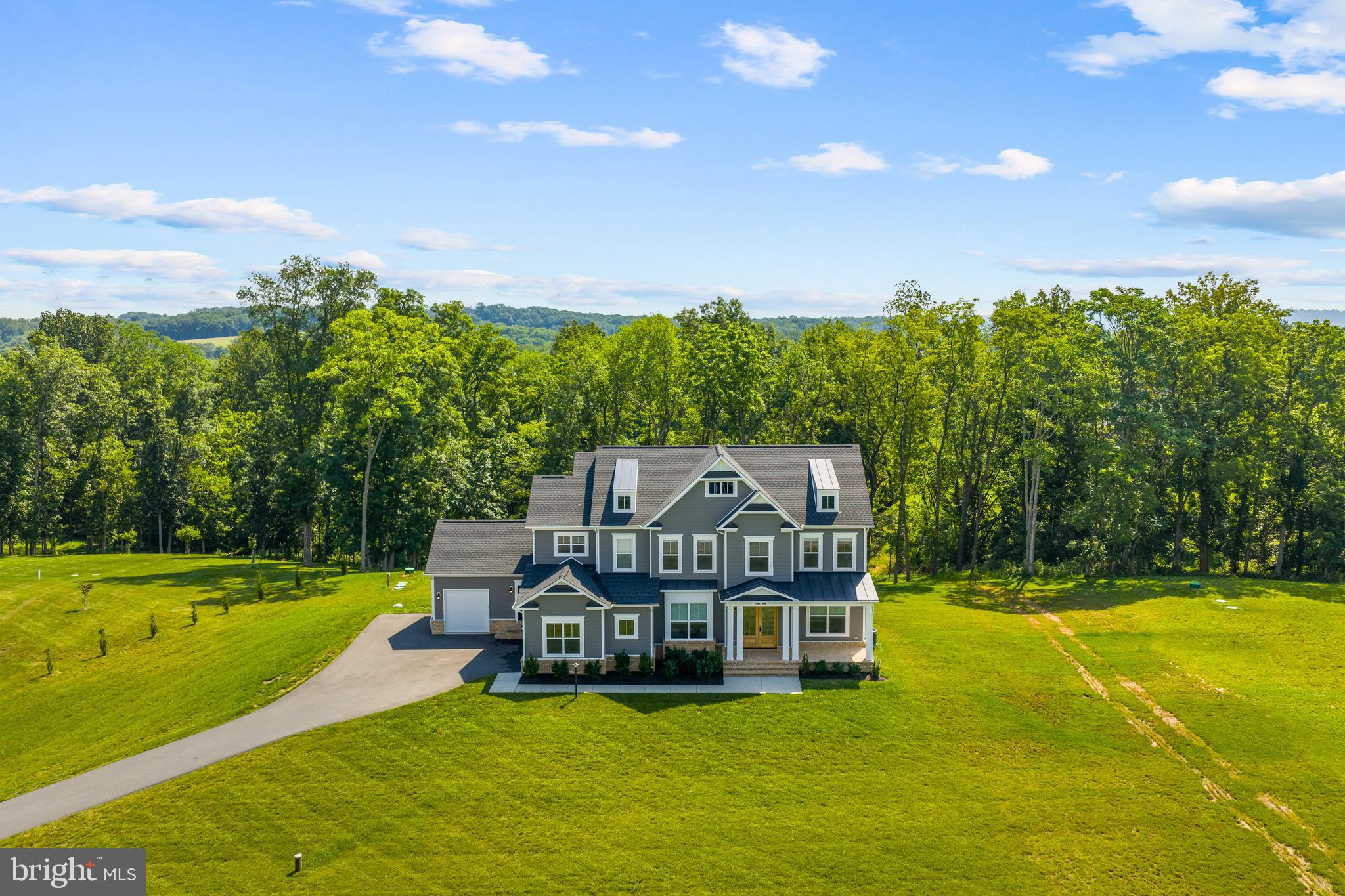 This stunning custom home built by Carrington Homes is set on over two private acres in Purcellville’s desirable Huntridge Preserve community. Built in 2022, this property offers beautiful curb appeal with a stately front elevation, manicured landscaping, and an extended driveway that leads to a spacious 3-car garage with its own dog washing station. Inside, the main level features wide-plank floors, elegant ceilings & mouldings, and an open-concept layout that includes a light-filled living room, a formal dining space, a private office, and a gourmet kitchen with upgraded cabinetry, quartz countertops, a large center island, a walk-in pantry, coffee bar, wine fridge, and wi-fi enabled stainless steel appliances. The upper level boasts four generously sized bedrooms, including a luxurious primary suite with vaulted ceiling and huge windows, two walk-in closets, and a spa-inspired en-suite bath with a freestanding tub, oversized shower with dual shower heads, heated floors, and two vanities. The upper level also includes three additional bedrooms - one an ensuite and the other two connected via a Jack-and-Jill bathroom. The well-appointed laundry room is also on the bedroom level.  The unfinished lower level is a blank canvas waiting for your customization. It has a rough-in for an additional bathroom and walk-up access to the backyard. Enjoy the peaceful setting from the back deck with a gas line for the grill and a screen-in porch surrounded by open green space—ideal for relaxing or entertaining. Located in Huntridge Preserve, a small HOA community with a monthly fee that includes trash and snow removal, and served by well and septic systems for added independence and privacy. Schedule a private tour to make this gorgeous home and lifestyle yours!