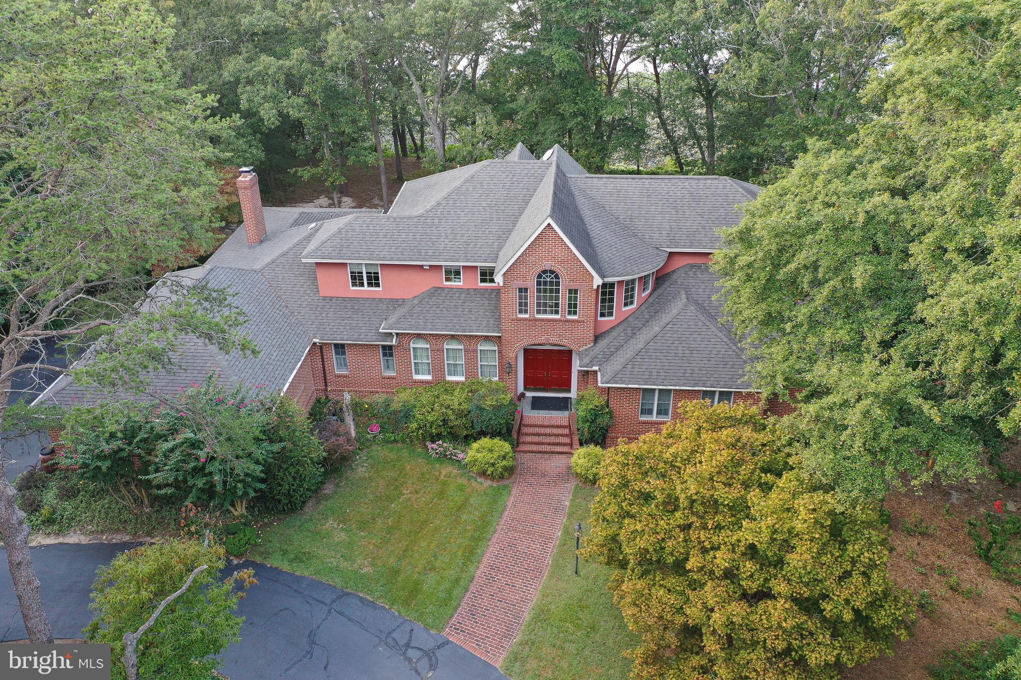 Waterfront Estate - Custom home, 2.87 acres, private pier on the Nanticoke River leading out to the Chesapeake Bay. Masterfully-designed to maximize waterviews from most every room, and built with exceptional craftsmanship on a double-lot in prestigious Holly Shores - a sought-after, established community of gorgeous homes, rich with nature - from bald eagles to herons and egrets. This 4BR/3.5BA home offers 3,591 sf above-grade living space, in addition to 784 sf finished walk-out basement living space and 522 sf of storage/workshop space. Flexible floorplan offers plenty of room to entertain or relax. Welcoming 2-story foyer features a lovely staircase.  Roomy kitchen with a darling breakfast nook. Formal dining room, perfect for celebrations, boasts a tray ceiling and chair-rail molding. Gather in the living room around the wood-burning fireplace w/convenient electric insert - or the family room w/wood-burning fireplace and vaulted ceiling. Library / office offers another flex space - with views of the front and rear yards. Convenient 1st floor bedroom and full bathroom. Half bath. Laundry room heads out to the attached 3-car garage. Upstairs, a true owner's retreat - spacious bedroom with private balcony, luxuriate in the full, en-suite bath - jetted tub, stall shower - stackable washer/dryer included. 2 additional bedrooms, a 3rd full bath, and a nice loft area open to the foyer complete the 2nd floor. Walk-out basement with finished recreational spaces, workshop, and storage spaces. Enjoy crisp Autumn mornings on the screened porch or deck. Community pier and boat ramp. Spend the day on the glorious Nanticoke River and out to the Chesapeake Bay. Low HOA of only $300/year. Minutes to unique dining, shopping, and events in Downtown Seaford - or a quick trip to the beloved Delaware Beaches for a rich and varied entertainment, world-class restaurants, boardwalks, State Parks, and more! Life in Sussex County is good - from the Beaches to the Bays and Beyond! Sizes approximate - per recent appraisal, taxes approximate. NOTE - Not pictured - Basement and closet interiors.