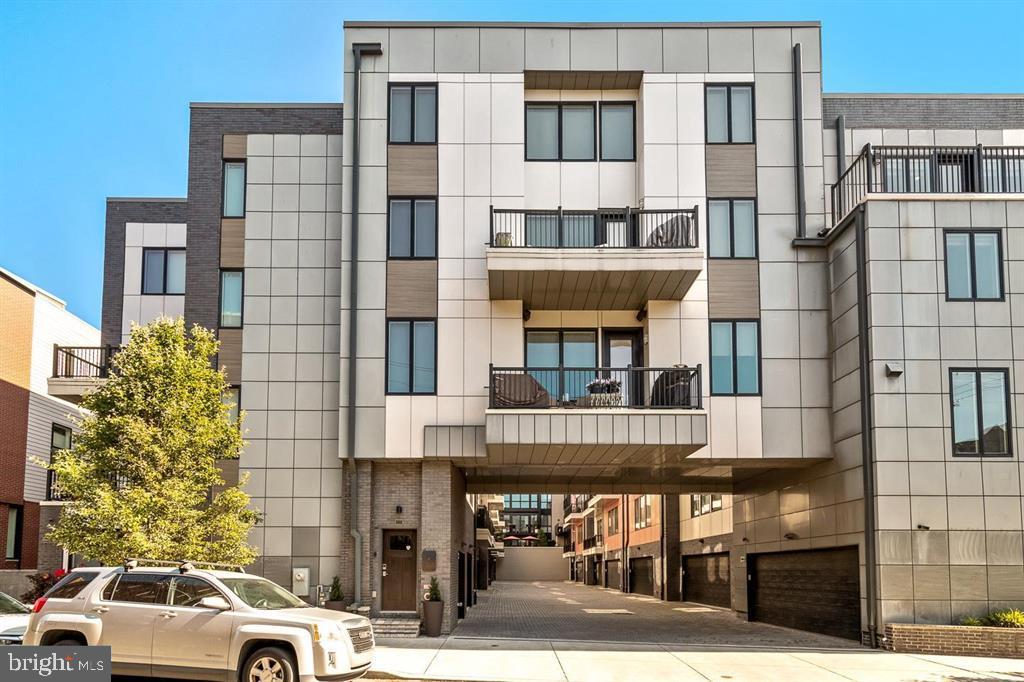 A rare offering in Northern Liberties, this luxurious 3 bed, 2.5 bath 2600+ SF carriage home is set in a private enclave and delivers a refined take on modern city living with an emphasis on natural light, scale, and seamless indoor-outdoor flow.  Elevated entirely above street level for added privacy, the residence opens into sun-drenched living spaces enhanced by a coveted southern exposure that fills the home with sunlight.  Wide-plank hardwood flooring runs throughout, complemented by integrated Sonos audio and custom Hunter Douglas window treatments, creating a thoughtfully curated and elevated living environment.

The gourmet kitchen is designed to impress with an open floorplan into the living room, blending everyday functionality with high-end entertaining appeal, and features custom cabinetry paired with premium Wolf and Sub-Zero appliances. The main living area is anchored by a striking fireplace, adding both warmth and architectural presence with an oversized balcony extending the living space outdoors.

Upstairs, the primary suite is positioned for comfort and privacy with a spa-inspired bath finished in rich stone and marble.  A separate laundry room with utility sink is discreetly located near the owner’s suite, maintaining the home’s clean and functional layout.  There is a bonus space perfect for home office or exercise room at the landing to the second level. Two additional ample sized bedrooms with large custom closets and a modern hall bathroom complete the level.  Additional highlights include an attached garage, a dedicated guest parking space, and a substantial storage area with direct access from the garage.

Perfectly situated just steps from Northern Liberties’ vibrant dining, boutique shopping, fitness studios, parks, and public transportation, this home offers a truly walkable lifestyle with convenient access to Center City and major highways. Combining thoughtful design, modern luxury, and a prime location, this is a distinctive residence that stands apart in one of Philadelphia’s most sought-after neighborhoods.