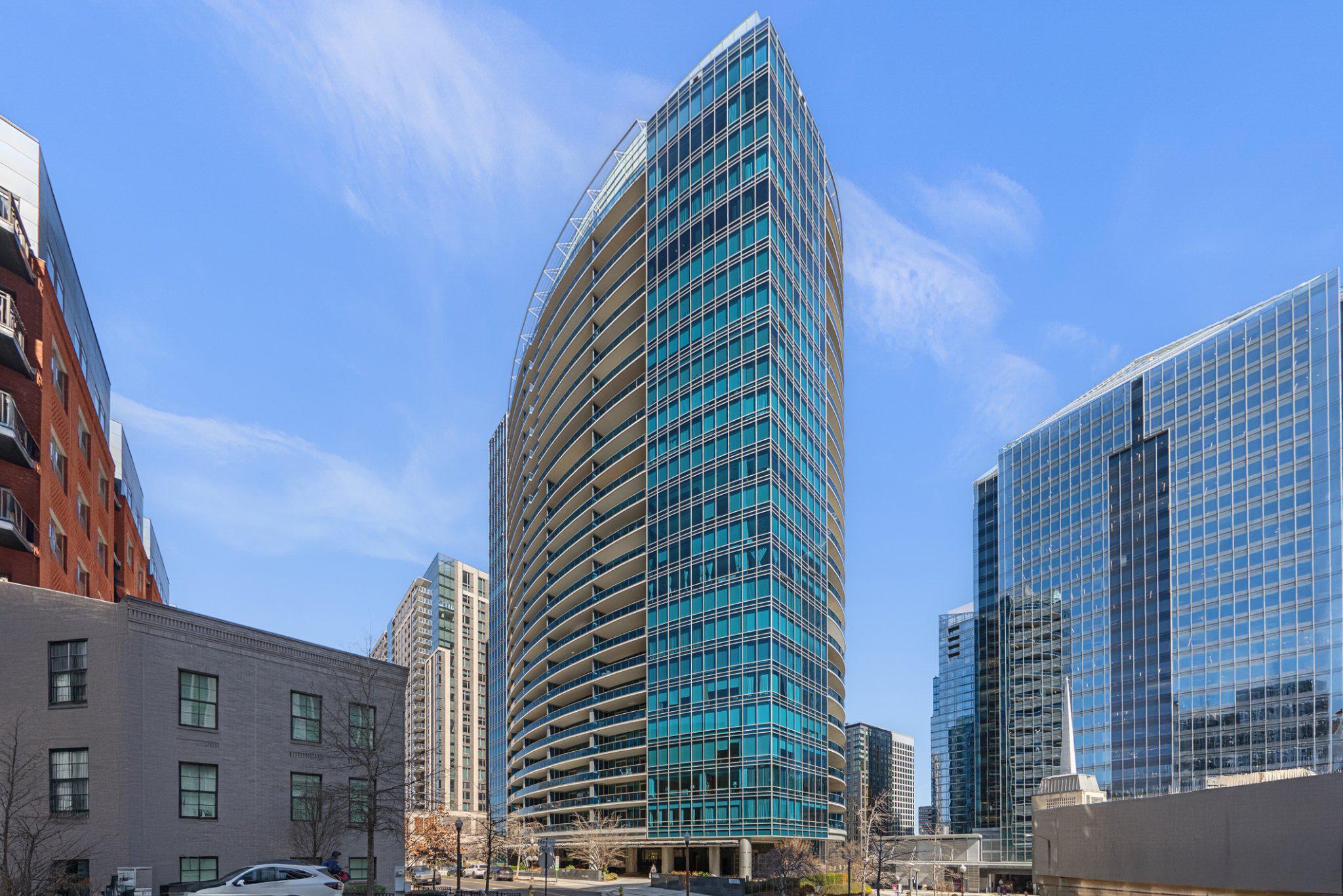 The choice of the DMV’s discriminating buyer, this exceptional residence at Turnberry Tower in Rosslyn offers a truly elevated living experience. Arrive in style with valet service for you and your guests. From the elegant lobby, take an elevator that opens directly to your residence—an impressive welcome home.      The spacious elevator foyer features built-in cabinetry for coats and footwear, along with ample space for your bikes or a bench. Inside, the open-concept layout, floor-to-ceiling glass and sophisticated modern finishes create a bright, inviting atmosphere with timeless appeal.      Indulge your inner chef. The gourmet kitchen is equipped with top-tier stainless steel Miele appliances, an integrated Sub-Zero refrigerator, granite countertops, under-cabinet lighting and a breakfast bar. It blends seamlessly with the living and dining rooms which open up to a large covered patio for relaxing and entertaining..
     The primary suite includes a comfortable seating area, a large walk-in closet with built-ins, and a motorized dual-shade system. The spa-inspired ensuite bath features dual vanities, marble floors and walls, a frameless glass shower with seating, and a Jacuzzi whirlpool hydrotherapy tub. The second bedroom also features motorized curtains and makes a great home office.      Additional highlights include marble, porcelain, ceramic, and hardwood flooring throughout, as well as tray ceilings in the living room and bedrooms.      This residence is enhanced by a professionally engineered smart home system to control air conditioning, lighting, window treatments, entertainment, and more from anywhere in the world. Enjoy whole-home audio, video-over-IP, and intuitive control via in-wall panels, remotes or your personal devices, all supported by professional-grade power conditioning. Unlike typical retrofits, this hardwired system provides seamless integration, superior reliability, and scalability.      Turnberry Tower residents enjoy white-glove amenities, including 24/7 concierge, security, and valet service, along with EV charging stations. Stay active in the state-of-the-art fitness center, indoor heated pool and spa. Entertain in the social lounge with catering kitchen, host movie nights in the private theater, or gather in the elegant atrium and outdoor terrace. The condo fee also covers water, gas, internet and cable.     Ideally located in the heart of Rosslyn, this home offers effortless access to Routes 66, 50, 395, and the GW Parkway. The Rosslyn Metro Station (Orange, Blue, and Silver lines) is just a short walk away, providing easy access to Reagan National and Dulles Airports. Walk to nearby Georgetown via the Key Bridge or explore the scenic Mount Vernon and Custis Trails for running and biking.      This is a smart buy! Own with pride in its understated elegance. Experience Turnberry luxury in person—book your private showing now.