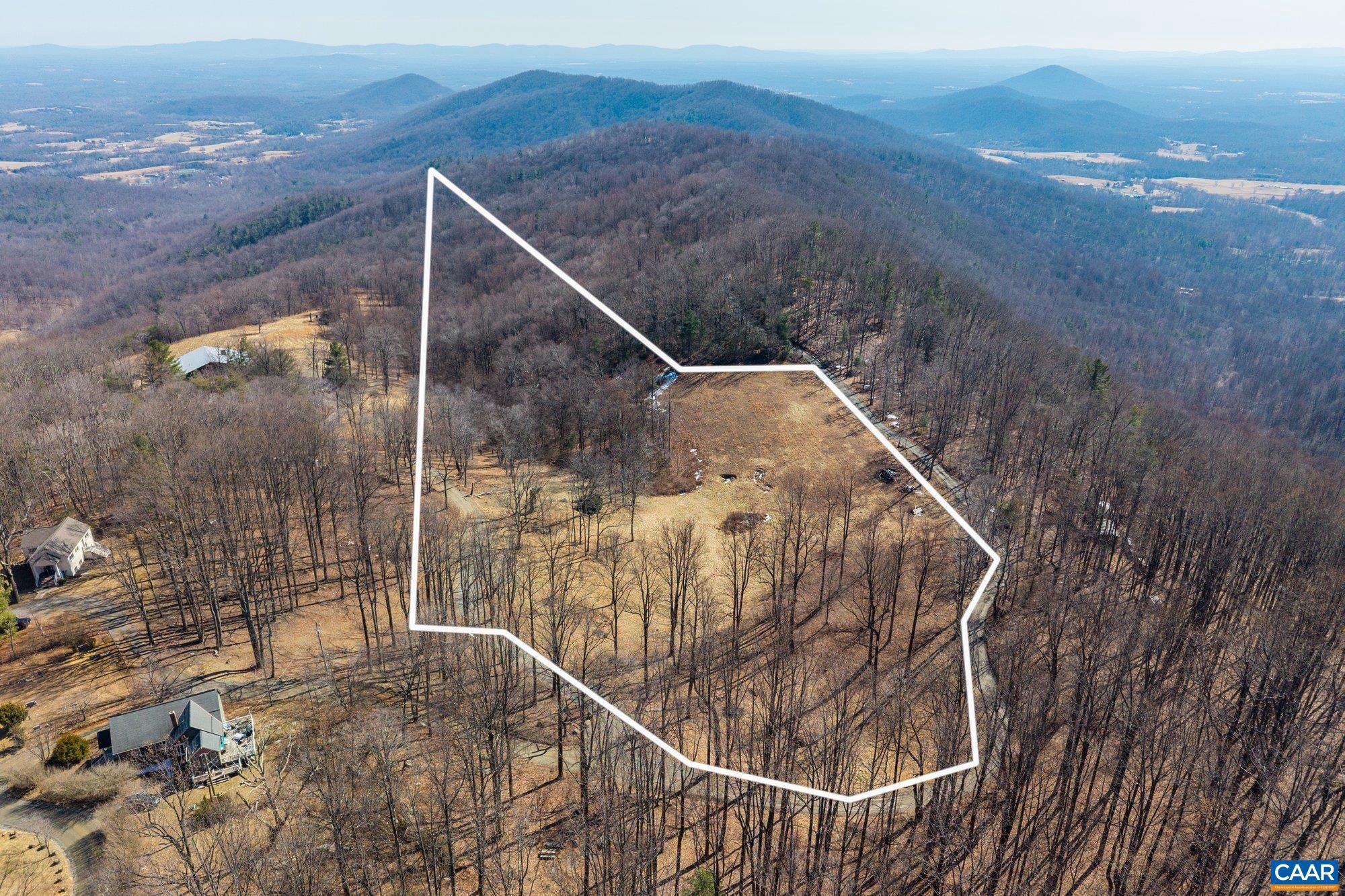This 8-acre parcel adjacent to Stone Mountain Estate offers a cleared homesite positioned to capture mountain views, with a small stand of woodland providing natural privacy behind the building site. Set at a high elevation in Central Virginia, the property enjoys a peaceful, open setting surrounded by mature forest and the quiet character of the larger estate. The ready homesite presents an ideal opportunity to create a primary residence or mountain retreat, combining open views with a manageable wooded backdrop. Conveniently located within reach of Charlottesville, the University of Virginia, and the region?s cultural and outdoor amenities, this offering is part of the larger Stone Mountain Estate listing with 78.99 acres.