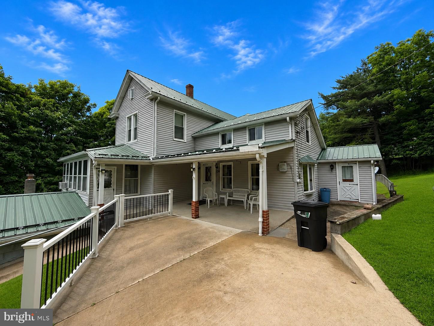 Step back in time without sacrificing modern comfort! Nestled on more than 4 picturesque acres, this exceptionally well-maintained 4-bedroom, 2-bath farmhouse is filled with warmth, character, and the kind of craftsmanship that's hard to find today. From the moment you enter, you'll be captivated by the stunning original woodwork, elegant staircase, and the pride of ownership evident throughout.
The spacious main level offers a primary suite with a private full bath, a convenient mudroom/laundry room, and a bright kitchen featuring heated tile floors. Stay comfortable year-round with central A/C, and enjoy peaceful mornings or relaxing evenings in the expansive wrap-around sunroom overlooking the beautiful grounds. Outside, the property is every bit as impressive. A large covered front porch welcomes guests, while the manicured acreage is dotted with mature apple trees, a classic stone spring house, and a historic potato cellar—adding both charm and a connection to the property's rich heritage. The partially fenced yard offers plenty of room for pets, gardening, or simply enjoying the serene surroundings. A 2-car detached garage, durable metal roof, and full basement provide practicality to match the home's beauty. If you've been dreaming of a classic country property that's been lovingly cared for and offers space, privacy, and timeless appeal, this is the one you've been waiting for. Properties like this rarely come along—schedule your private showing today! *Some Photos are Virtually Staged*