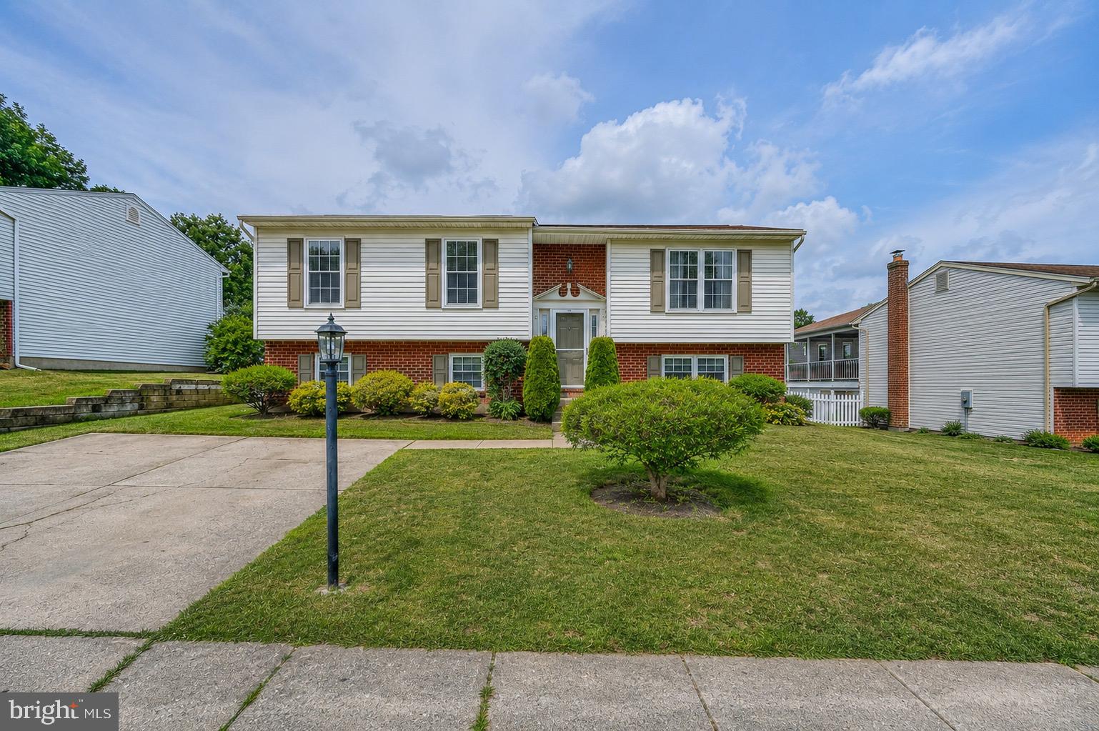 Beautifully updated and move-in ready, this spacious 2,300-square-foot split foyer in the desirable Oakhurst community offers 4 bedrooms, 2 1/2 baths, and the perfect combination of stylish updates and functional living space.Step inside to a bright, inviting interior featuring fresh paint, updated modern lighting, recent carpet in LL,  and durable laminate flooring.  The welcoming tiled foyer includes a built-in drop zone with shoe storage, creating a practical and organized entryway.
The spacious eat-in kitchen is the heart of the home, boasting stainless steel appliances, ceramic tile flooring, and an oversized center island with seating for four- perfect for everyday living and entertaining. French doors lead to a large maintenance-free composite deck with vinyl railings overlooking the fully fenced backyard, with mature landscape for privacy, a paver patio,  fire pit and  shed. The main level features three generously sized bedrooms, each with ceiling fans, including a comfortable primary suite with private bath. The recently remodeled lower level expands the living space with a bright and spacious family room featuring a cozy corner gas fireplace, elegant wainscoting, large windows that fill the space with natural light, brand-new carpet, fresh paint, a convenient half bath, and the 4th bedroom. An additional bonus room with its own private rear entrance and large storage closet offers endless possibilities as a home office, gym or hobby space. Additional highlights include an  laundry room with front-loading washer and dryer, utility sink, and portable shelving,  a storm door; updated central air conditioning components (2024) and convenient off-street parking.This thoughtfully updated home offers the space, flexibility, and modern finishes today's buyers are looking for—all in an established neighborhood close to shopping, dining, parks, and commuter routes.