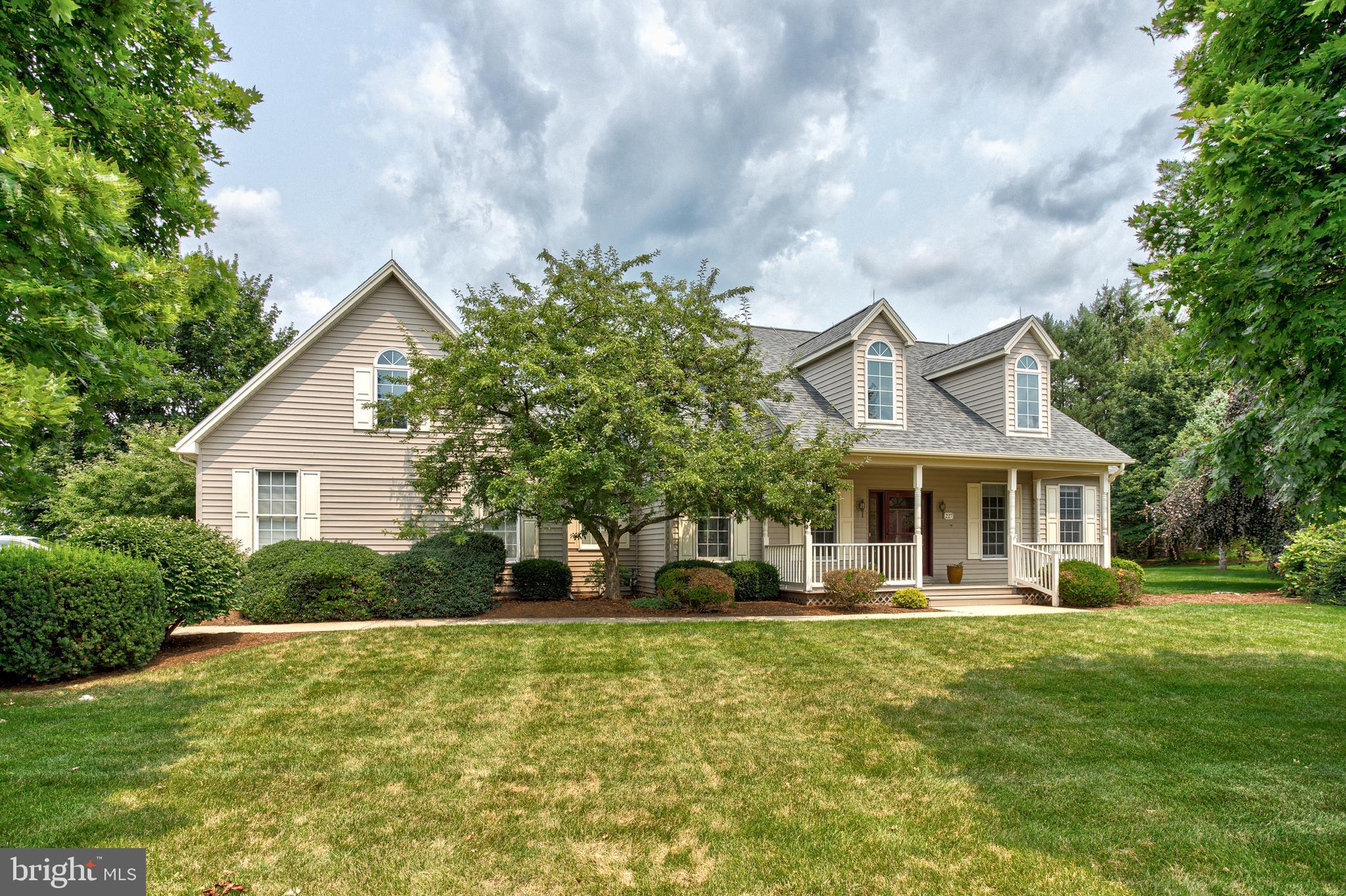 Discover luxury retirement living with breathtaking views in the coveted Village Heights Neighborhood. This elegant Cape Cod single-family home offers ideal one-floor living, highlighted by a spacious Owner’s Suite featuring vaulted ceilings, an updated private bath with a separate shower and tub, and a generous walk-in closet. Two additional well-sized bedrooms, another full bath, and a convenient half bath provide comfort for residents and guests alike. The inviting eat-in kitchen is equipped with abundant cabinetry and modern stainless-steel appliances, perfect for everyday meals or entertaining. The bright living room showcases a cozy gas fireplace, while the formal dining room is conveniently located just off the kitchen. Main-floor laundry and ample closet space add everyday ease. Upstairs, a finished family room with vaulted ceilings and skylights offers a fantastic bonus space. Beautiful hardwood flooring flows through much of the main level.  Enjoy relaxing on the welcoming covered front porch or take in unbelievable panoramic views from the expansive partially covered back deck overlooking the golf course, Nittany Valley, and Beaver Stadium. Community amenities include a heated pool, hot tub, fitness center, library, and private restaurant—all covered by the monthly condo fee. Additional services such as sewer, water, trash and recycling, basic cable, secured entry, grounds maintenance, snow removal, and exterior upkeep are also included.