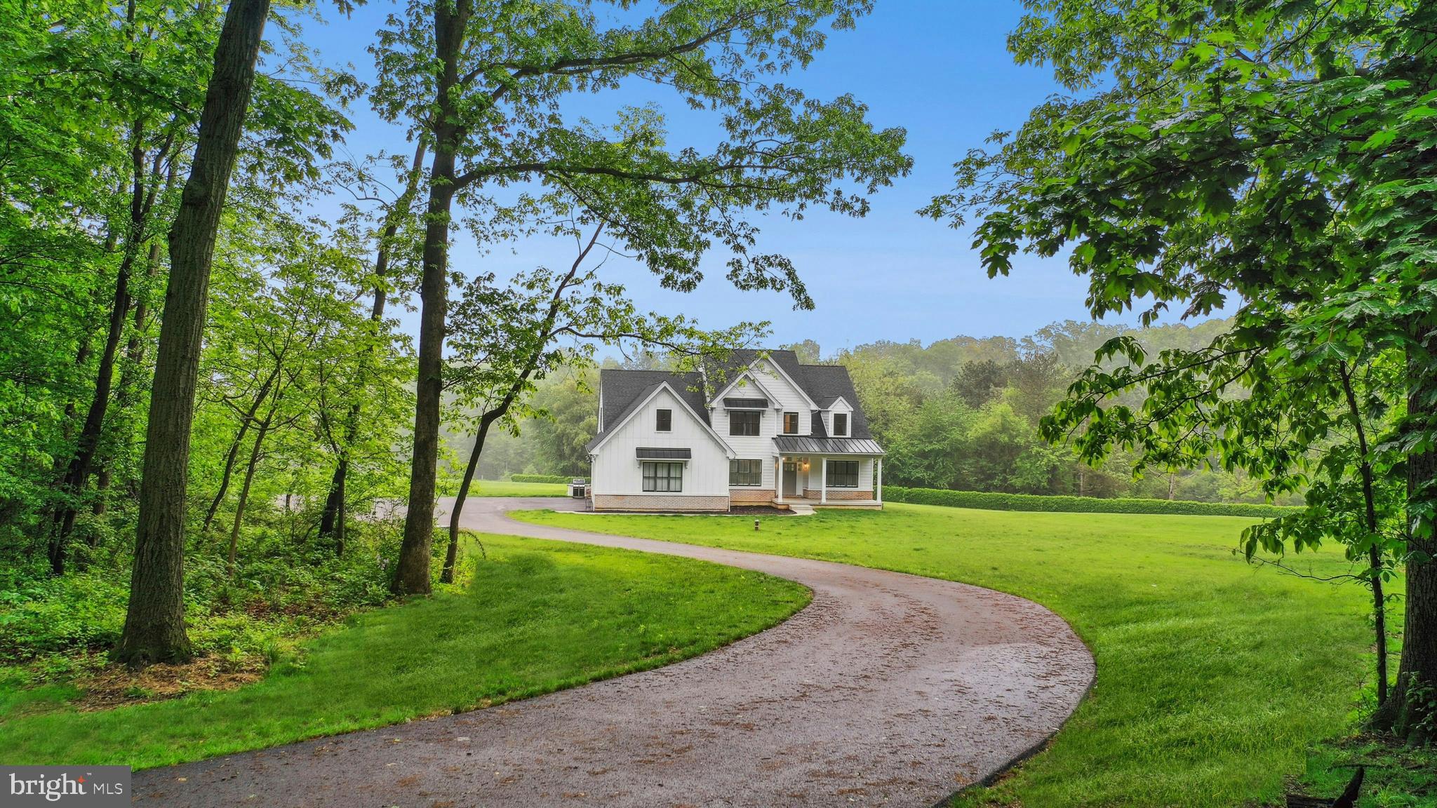 A premium lot in Bushkill Township is the setting for this newly built colonial on 4 acres. Back a winding driveway, Meadowhouse offers high ceilings, abundant windows, and a spacious backyard with big sky and long distance views.
     The floor plan is open and brimming with sunlight. The foyer opens gracefully to the formal dining room, with French doors leading to the nearby office. A spacious living room boasts a brick fireplace with gas insert, with access to a sunroom for year round enjoyment of the lush surroundings. The state of the art kitchen includes soft-close cabinets, quartz countertops, and high-end stainless appliances. There is seating available at the island as well as a breakfast nook and a pantry for storage. The primary suite is also located on this level, with vaulted ceiling, a large walk-in closet, and luxe private bath. On the second floor, 3 bedrooms and 2 full baths are complemented by a carpeted family / bedroom, ideal for entertaining guests of all ages.
     Convenience continues with the attached 3 car garage and first floor laundry. Expansion opportunities abound in the unfinished lower level with tall ceilings. The home’s desirable location in the Nazareth school district offers exceptional access to commuter routes I-22 and 33, thriving businesses, prominent hospitals and recreational hot spots in the Lehigh Valley.