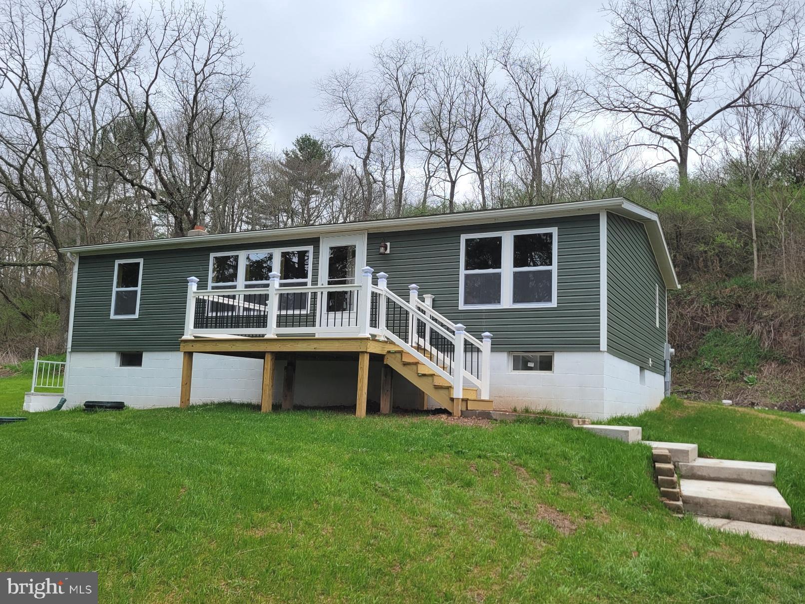 Affordable & Adorable - Country setting for this beautifully renovated rancher on one acre lot, 3 bedrooms, 2 full baths, open floor plan, all new walls, floors, ceilings, new kitchen and new bathrooms, new lighting, new tilt windows, new decks, full unfinished basement with outside exit...imagine the possibilities.   Detached double garage, perfect for the hobbyist.  View of  trees, stream and pastures.  Great getaway property or year 'round living.  Located 1.5 miles from I-70.   Garage lies within 100 year flood plain.  This is truly a gem.   Call today to schedule your showing.