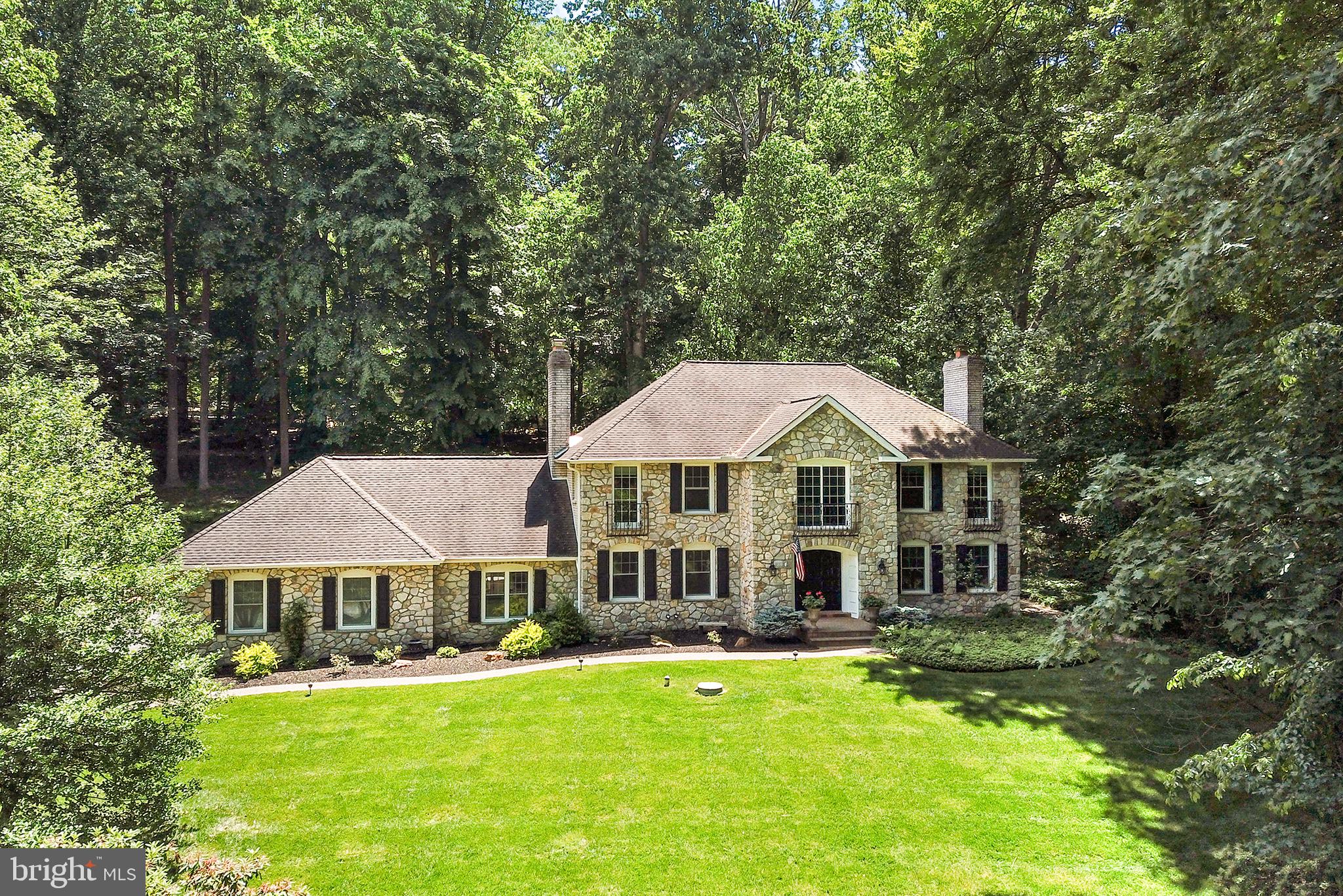 Welcome to this magnificent 4-bedroom, 3.5-bathroom residence nestled in a prestigious neighborhood near Springton Reservoir. This home exudes elegance and sophistication, featuring a breathtaking sunroom and an expansive open eat-in kitchen, perfect for culinary delights and memorable gatherings. Approach this home past the attractive professionally landscaped flower beds and enter into the large foyer.  The entry space connects to the living room/dining room, the home office, a powder room and passes through to the gourmet kitchen.  The living room features a wood burning fireplace and open floor plan perfect for entertaining. A truly impressive kitchen with dining area, butlers pantry, prep island and stainless steel appliances connects to an inviting sunroom with windows on all sides to access the perfect breeze or watch snow collecting in the yard.  Just off the kitchen is a recessed family room with a second gas fireplace, built in cabinets and access to a second partially covered patio.  Also on this level is a mudroom/laundry room with full bathroom and access to the attached garage.
The grandeur of the curved staircase leads you to the upstairs landing, a great place to reflect and glimpse the sunset views. Beside the sitting area is a luxurious primary suite, complete with double walk-in closets and a modern en-suite bathroom, showcasing a sumptuous soaking tub. Three additional bedrooms are found on this level each with copious closets and lighted ceiling fans.  The hall bathroom services these rooms.
Step outside to the exquisitely hardscaped two-level patio and a secluded grassy yard, providing a serene oasis for outdoor enjoyment. The two-car garage adds convenience and complements the impeccable curb appeal of this stunning home.
Situated in an area renowned for its top-rated schools, this property is also in close proximity to Media Borough, Rose Tree Park, and Ridley Creek State park for scenic walking trails. Experience the epitome of refined living in this exceptional home, where every detail has been thoughtfully designed to offer unparalleled comfort and style. Don’t miss the opportunity to make this extraordinary residence your own!