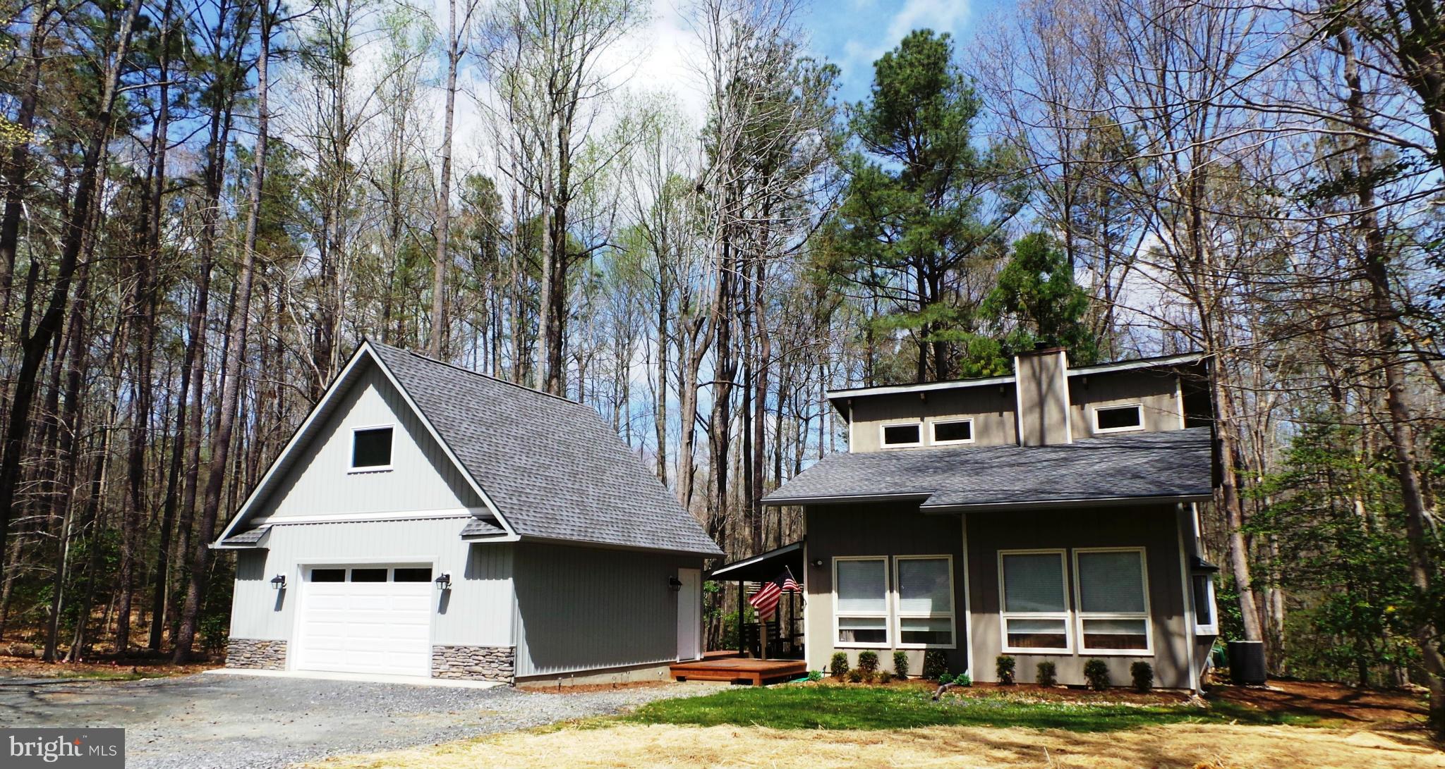 NESTLED ON 5 ACRES THIS VERY UNIQUE CONTEMPORARY BUILT 3BR, 3 BA, 2 CAR DETACHED GARAGE w/ HUGE LOFT OFFERS SIDE AND BACK DECK WELL SUITED FOR CASUAL GATHERINGS OR SOLITUDE. NEW WELL, FRESH PAINT, HARDWOOD,CERAMIC,STAINLESS APP, PANTRY, W-STOVE & HIGH CEILINGS.BR & FULL BATH ON MAIN LEVEL.SECOND BR, MASTER w/ WI & SOAKING TUB- 2ND LEVEL. CLOSE TO SHOPPING,HOSPITAL,SCHOOLS...GREAT LOCATION!