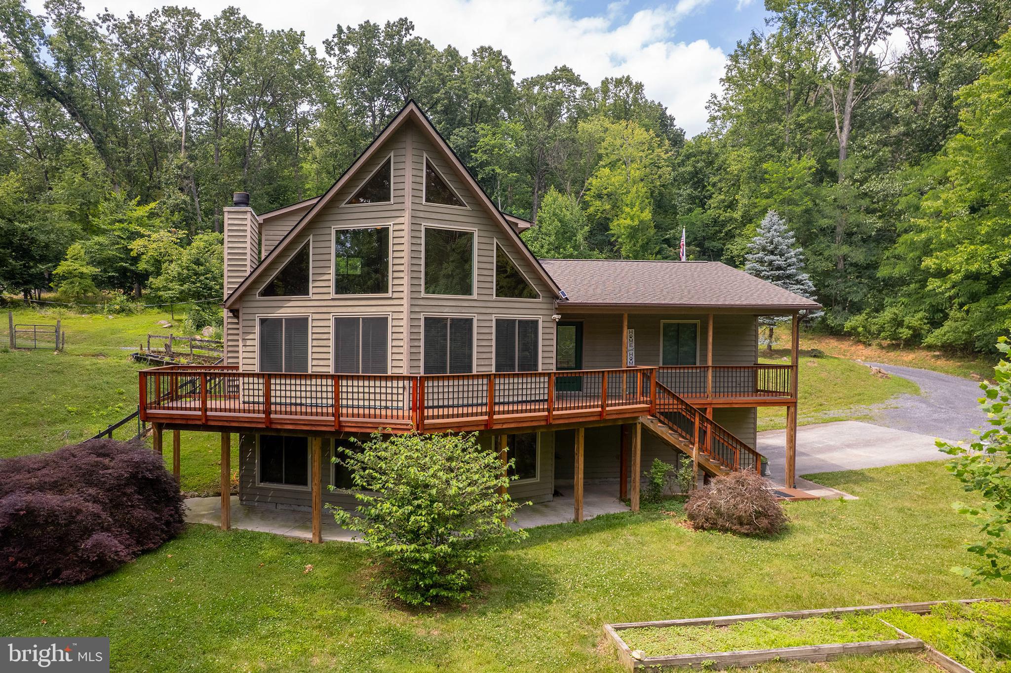 THREE-PARCEL COMPOUND | SHENANDOAH NATIONAL PARK BUFFER | FRONT ROYAL, VA

Rare opportunity to own a fully improved, three-parcel compound totaling 8.6± acres — sold together as one package. Chalet-style main home, a massive finished garage, and a wooded buildable lot, all separated only by a permanently protected 50+ acre family trust buffer from Shenandoah National Park. No future development behind you — ever.

THE HOME | 1.9 ACRES
Move-in ready chalet (2004) with 3 BR / 3 BA. Recent updates include refinished hardwood floors, fresh interior paint, new roof, and new windows. Fenced yard with dedicated chicken coop and roosting outbuilding — ready for hobby farm use from day one. Own well and septic. Open, established landscaping.

THE GARAGE PARCEL | 1.7 ACRES
30x40 finished, insulated, powered garage with attached covered lean-to machine run-in — a serious workshop, equipment barn, or vehicle storage solution. Well and septic already installed on parcel. Garage is pre-plumbed for a bathroom and kitchenette. Connect service and finish the interior, and this becomes a fully independent guest house, ADU, or second primary residence. Fully buildable lot. Mixed open and wooded terrain.

THE WOODED LOT | 5 ACRES
Mostly wooded with septic already installed. Fully buildable — site a cabin, guest cottage, or future primary structure. Natural privacy from neighboring parcels. Exceptional long-term hold or build-to-suit potential.

THE SETTING
Just minutes from the South Fork of the Shenandoah River and the shops, restaurants, and craft breweries of Front Royal. The only neighbor behind you is the National Park itself, buffered by preserved family trust land that guarantees this view and privacy in perpetuity.

Investors may wish to independently research short-term rental and multi-unit potential with Warren County zoning. Info deemed reliable but not guaranteed.