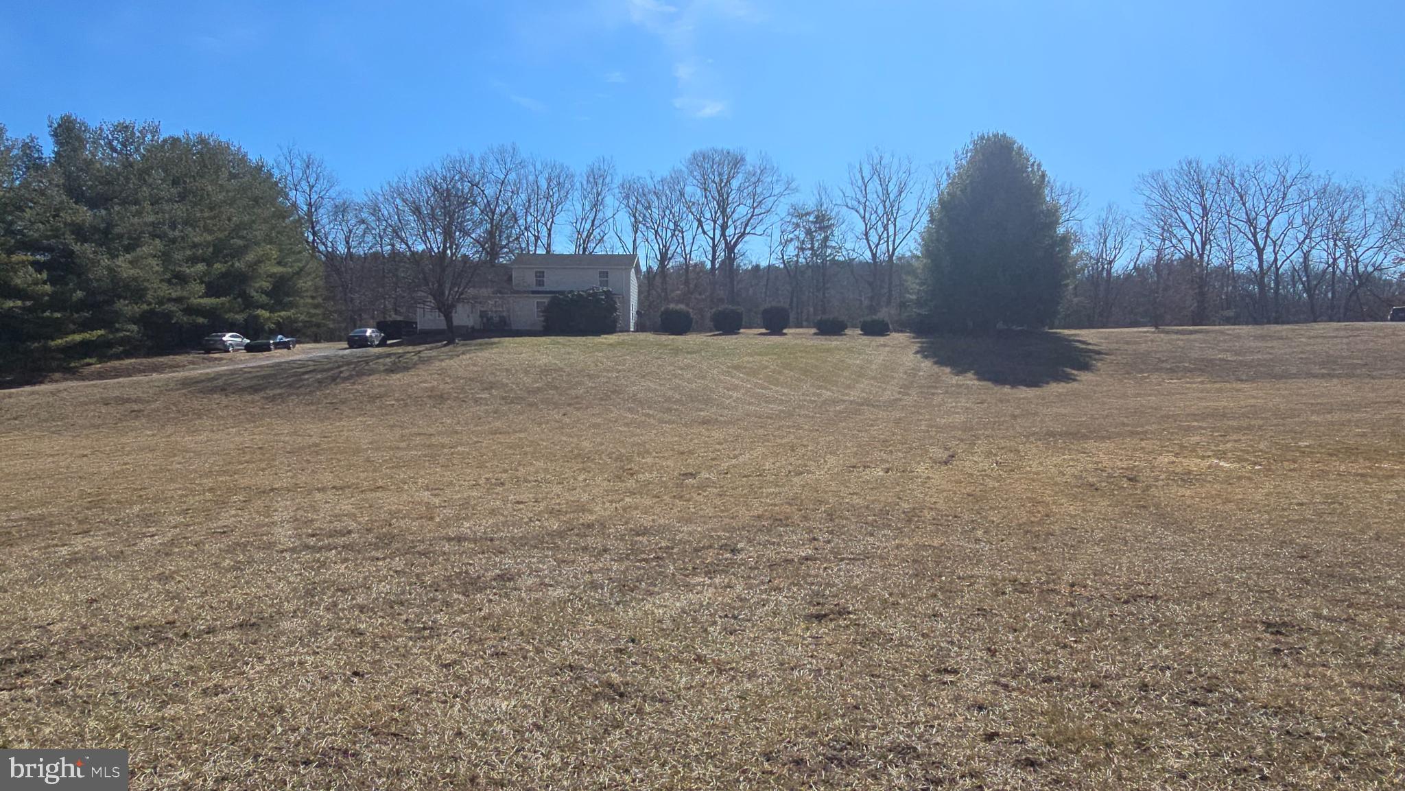 Situated  on 2.51 acres, this 4 bedrooms, 3 Bath home could be your forever home. This  country home is conveniently located approximately .1 miles off of Bloomery Pike in the quaint little community of  Slanesville WV . 

Walking inside you will find a nice size  living room with two ceiling fans, perfect for gatherings or just relaxing after a hard days work .  The kitchen has brand new LVP flooring and updated appliances, new faucets, and a brand new exterior French Door leading to the back yard. The walk in  pantry and a laundry room  are  also located on the main floor.  Do you need a Primary Bedroom and Bathroom on the Main Floor? Well your problem is solved. The Primary bedroom is tucked away with plenty of separation from the rest of the home. The large walk in shower is also a  plus. As you go upstairs, the 3 bedrooms and bathroom upstairs, will fit any size home you may need. The flooring in Bedrooms 3 and 4 does need floor covering. If that becomes an issue, it will be addressed. So get out of the city and own your little piece of West Virginia countryside, this house is located on an awesome, unrestricted lot. You can bring your chickens,  grow your garden or just enjoy an evening walk, the opportunities are  endless. This home also has a bonus room which could easily be a fifth bedroom if needed. It  is Fiber Optic ready through Frontier Internet. There is also a  shed if you need  extra storage space and a nice sized fenced in yard.

Check out the list of improvements that have been made:

Well pump was replaced in 2020
Washer was replaced in 2020
New gutters in 2022
New refrigerator in 2021
New stove and dishwasher in Dec 2024
HVAC system was pressure tested and recharged in 2023
HVAC compressor fan motor replaced in 2023 (upstairs unit)
HVAC starter capacitor replaced in 2023 (both)
Septic tank recently pumped in 2024
The Kitchen and Dining Room Floors were just replaced withLVP Flooring.
The back French door was completed replaced at the same time. 

There are still more updates and repairs to be done, but the opptunities are there to take this home from ok to amazing. There has been a lot of interest already on this home, don't miss your chance,   schedule your showing today.