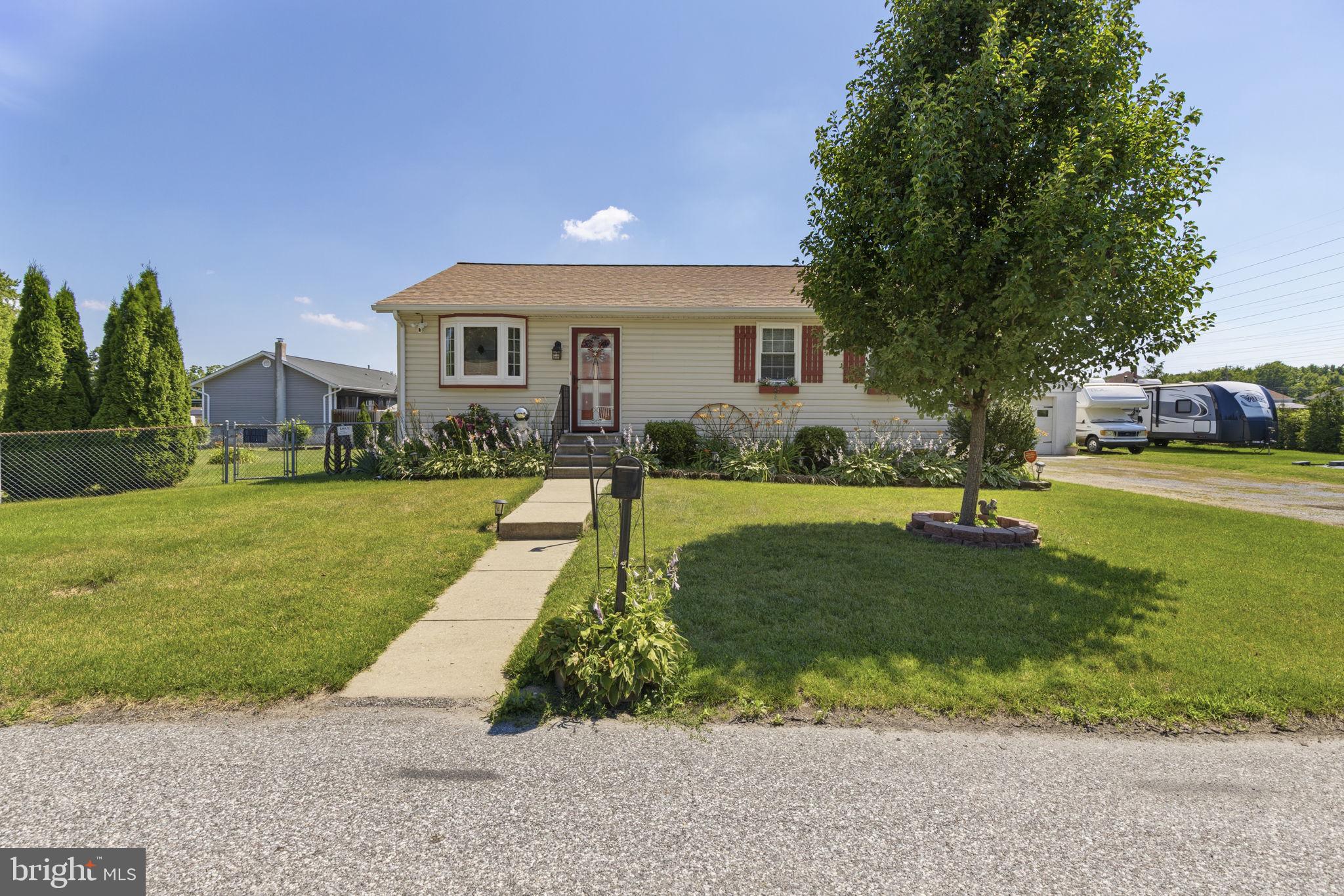 Welcome to this impeccably maintained ranch-style home offering over 1,900 square feet of finished living space, exceptional updates, an incredible detached garage, and the rare opportunity to own an adjoining separately deeded corner lot—all in one package.

Nestled near the end of the street, this beautifully maintained property offers a peaceful setting while remaining conveniently located near shopping, dining, and major commuter routes.

The main level features approximately 1,200 square feet with two generously sized bedrooms, including an oversized primary bedroom with a large walk-in closet. The beautifully updated full bathroom includes a spacious walk-in shower with a built-in seat. The kitchen was tastefully renovated in 2019 with soft-close cabinetry, granite countertops, and stainless steel appliances, creating a space that is both functional and inviting. Luxury vinyl plank flooring installed in 2020 adds warmth, durability, and a modern touch throughout much of the main level.

The finished lower level adds approximately 700 square feet of additional living space and is ideal for entertaining, relaxing, or everyday living. It features a spacious family room complete with a bar, a convenient half bath with the potential for future expansion to a full bath, and a large utility room offering a washer, dryer, utility sink, sump pump, and abundant storage space.

Outdoor living is just as impressive. Enjoy the private patio with a hot tub that conveys with the property, while a rear ramp provides convenient access from the oversized driveway to the main level entrance. The extra-wide driveway accommodates multiple vehicles with ease.

Car enthusiasts, hobbyists, RV owners, and anyone needing exceptional workspace will appreciate the impressive 27' x 27' detached garage featuring electric service, an upper loft for additional storage, a 30-amp RV hookup, and a propane heater that is currently not connected. The detached shed is also wired with electricity, providing even more flexibility for storage, hobbies, or workshop space.

This home has been meticulously maintained with numerous major updates, including:
• HVAC replaced in 2019
• Kitchen renovation with soft-close cabinetry, granite countertops, and stainless steel appliances (2019)
• Bay window and primary bedroom windows replaced (2019)
• Luxury vinyl plank flooring installed (2020)
• New roofs on the house, detached garage, and shed (2021)
• Sump pump replaced (2021)
• Water heater replaced (2022)

One of the most unique features of this property is that it is being sold together with the adjoining separately deeded corner lot. Public water and sewer are available at the street, providing exceptional flexibility for future plans, additional outdoor space, or long-term investment potential. Opportunities like this are becoming increasingly difficult to find.

Move-in ready and meticulously cared for, this exceptional property combines quality craftsmanship, thoughtful updates, abundant indoor and outdoor living space, outstanding garage and storage options, and the added value of an adjoining parcel—all in one remarkable offering.