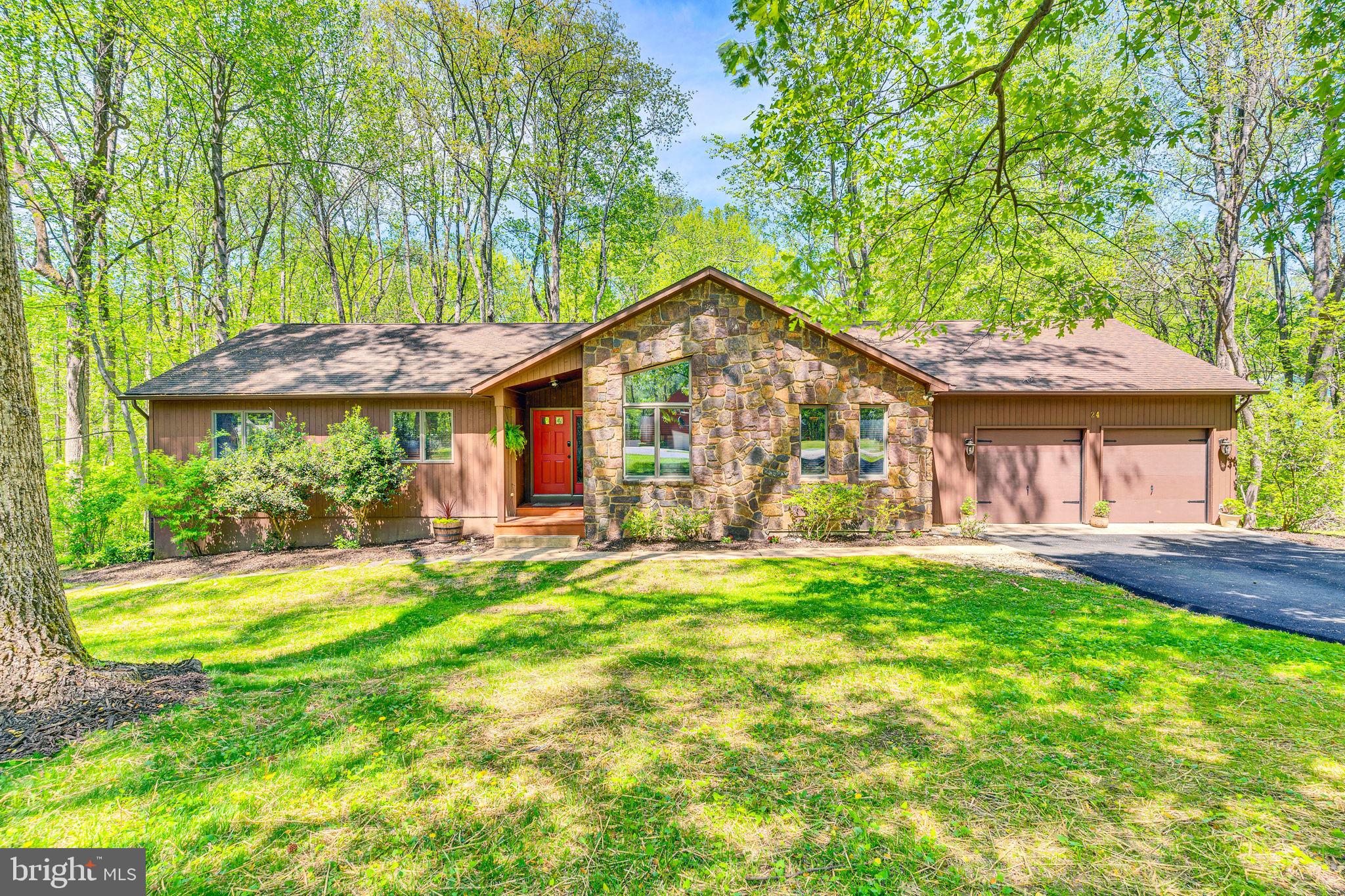 Nestled in the picturesque community of Friendship Woods, this charming 4-bedroom, 3-bathroom home spans approximately 3,510 sq. ft of total living space. and features an inviting open contemporary layout! The kitchen boasts granite countertops and stainless steel appliances, while the family room is anchored by a charming stone wood-burning fireplace. With hardwood floors on the main level and new carpet throughout, this home seamlessly blends comfort and style. Step outside onto the 16x12 deck, where you can unwind while enjoying the tranquil views of the wooded lot and the privacy it offers. The fully finished basement offers additional living space, including a bedroom, a full bathroom, and a cozy pellet stove. With a 2-car garage and a beautifully landscaped backyard equipped with a fire pit entertainment area, this home is designed for comfort and enjoyment!! Close to beaches, marinas, and restaurants!