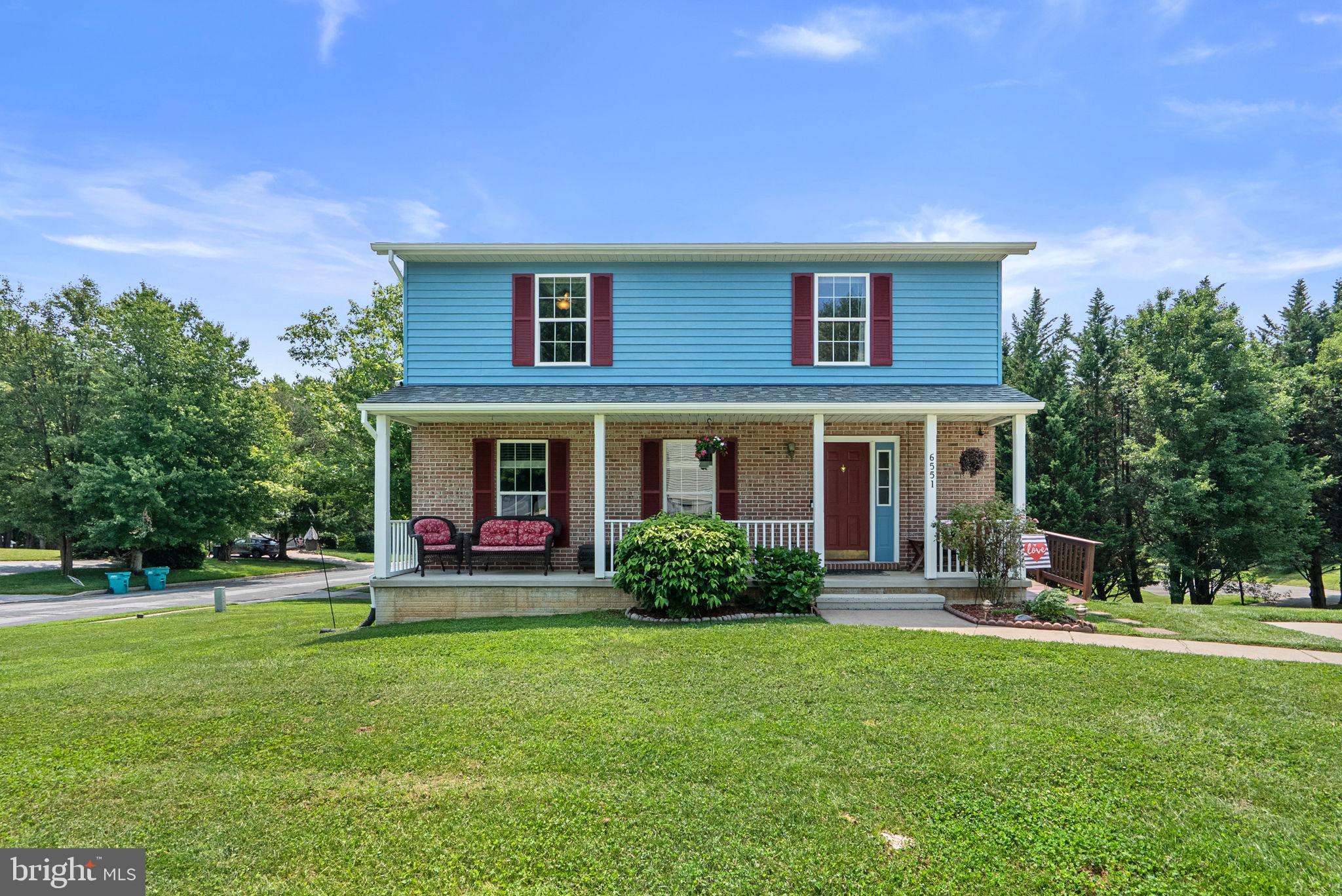 Nestled on a picturesque corner lot in the sought-after Benjamins Claim community, this charming Colonial offers timeless curb appeal, highlighted by a welcoming front porch. Inside, you'll find 4 bedrooms, 2.5 bathrooms, and 1,888 finished square feet of comfortable living space designed for everyday living and entertaining. Thoughtfully designed for both everyday living and entertaining, the main level showcases beautiful hardwood floors throughout the spacious formal living room, complete with a cozy gas fireplace, an elegant formal dining room conveniently located off the kitchen, and a warm, inviting family room. A sliding glass door from the family room opens to the deck, creating a seamless indoor-outdoor flow that's perfect for entertaining or enjoying a quiet evening outdoors. The spacious eat-in kitchen offers ample counter and cabinet space, durable tile flooring, and a beautiful bay window that fills the room with natural light while providing picturesque views of the lush backyard.  The upper level features a spacious owner's suite filled with natural light, complete with a private en-suite bathroom. Three additional generously sized bedrooms, a full hall bathroom, and carpeting throughout complete the upper level. The unfinished lower level offers additional storage space and convenient access to the lower-level patio and inviting fire pit area, creating the perfect space for outdoor gatherings. Additional features include a large carport and ramp access from the driveway to the spacious back deck, providing both convenience and accessibility.