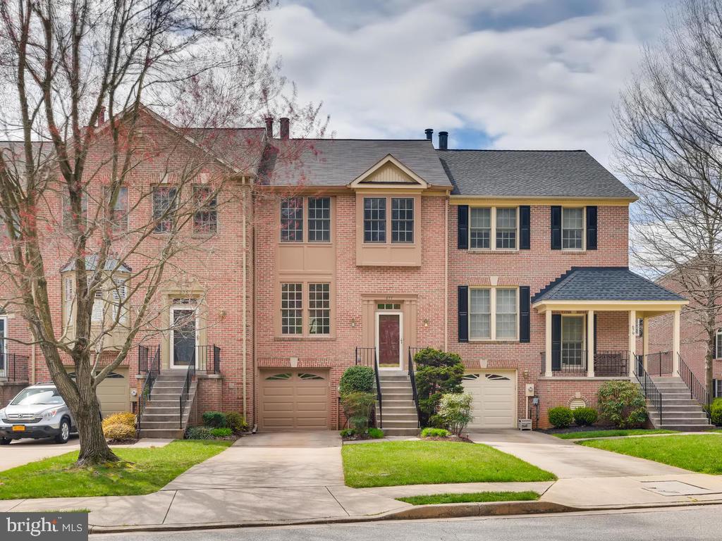 Your patience has finally paid off!  This exceptional, welcoming townhome has it all.  Step inside and be greeted by warm, neutral hues, gleaming hardwood floors, soaring ceilings, crown molding, a handsome 3-sided  wood burning fireplace and upgraded lighting.  The open kitchen is a stylish collaboration of clean lined traditional cabinetry and granite counter tops, stainless steel appliances and a custom back-splash.  The kitchen has amazing views.  Imagine waking to the  picturesque greenery on the expansive deck with an awning or the blue stone  patio,  both of which create lovely outdoor retreats.  The second level has neutral carpet and spacious bedrooms with vaulted ceilings.   The master suite is sophisticated, and the master bathroom features a luxurious soaking tub, a double vanity, beautiful tiled shower with a 7' frame less shower door, and let's not forget the heated floor! Did we mention the California Closet in the master bedroom?  All of the elements, amenities and attention to detail are covered; they are high end and modern. The lower level boasts a finished living/play area  with a gas fireplace and updated powder room, as well as sliders leading to a lovely patio.  Connected is an organized garage and storage area.  Style and serenity make for winning a combination.  This home is newly vacated, and ready for your in-person tour!