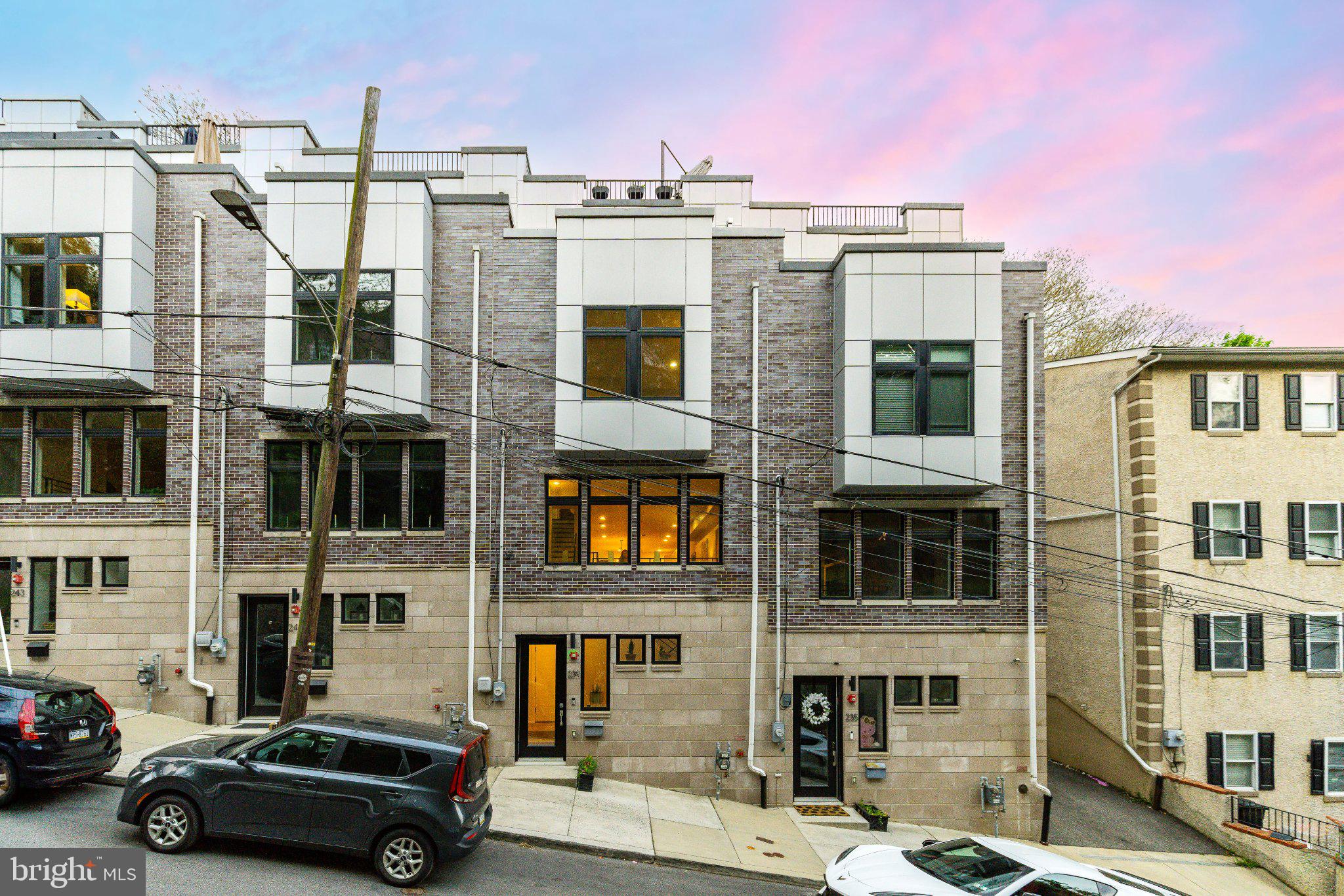 Welcome to 239 Lyceum Avenue, an exceptional opportunity to own one of just 5 luxury townhomes built into the iconic Manayunk Wall. Blending city convenience with a serene, elevated setting, this residence spans 3 thoughtfully designed levels and offers gated parking for 2 cars, 3 private outdoor spaces, and generously scaled bedrooms, including a full floor primary suite. Among the 5 homes, this property features one of the largest outdoor footprints. Tax abatement ends in 2029.

A welcoming foyer with 9 foot ceilings leads into a freshly painted open concept main level designed for both everyday living and effortless entertaining. The kitchen serves as the centerpiece, featuring abundant storage, high end appliances, and a large island ideal for casual dining and meal preparation. Just beyond, a secluded patio creates a peaceful extension of the living space.

The second floor offers two spacious bedrooms with walk in closets, a full bath, and conveniently located laundry.

The entire third level is dedicated to a light filled primary suite, where floor to ceiling windows and sliding doors open directly to a private balcony with sweeping views of the Manayunk Bridge and Cynwyd Heritage Trail. Enjoy morning coffee outdoors or unwind beneath the stars. The suite features a large walk in closet and a spa inspired bath with a soaking tub, glass enclosed shower, double vanity, and heated tile floors.

Above, the expansive rooftop deck spans the length of the home and is equipped with lighting, electricity, and water, ideal for entertaining or container gardening. In 2025, the owner invested in a premium Duradek vinyl membrane roof system and new siding, offering superior long term waterproofing and supported by a 15 year manufacturer warranty.

Ideally located, this home provides seamless access to Center City and the suburbs. It is a short walk to SEPTA Regional Rail, with nearby access to express bus routes 27 and 9 into Center City, and just minutes from I 76. With 2 gated parking spaces, convenience is always assured.

Enjoy close proximity to Manayunk, Roxborough, and Chestnut Hill with a vibrant and growing dining scene, including local favorites such as Pizza Jawn, White Yak, Market at the Fareway, Weavers Way Co op, the Pretzel Park Farmers Market, and Dead King Bread. Outdoor enthusiasts will appreciate easy access to the Cynwyd Heritage Trail, Towpath, and Wissahickon Valley Park.

Positioned along the route of the renowned Manayunk Bike Race, this home offers a front row experience at one of Philadelphia premier events. With 2 private balconies overlooking the action, entertaining here is truly unmatched.

A rare opportunity for urban living in a tranquil setting.