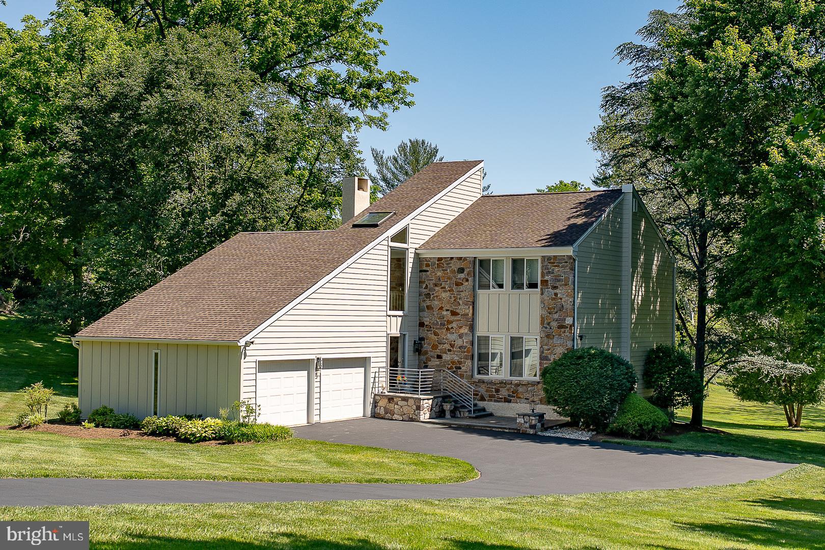 Welcome to this beautifully updated 4-bedroom, 3.5-bath contemporary home in sought-after Bryn Mawr, located within the award-winning Radnor School District. Set on a picturesque 0.7 acre lot, this exceptional property combines thoughtful upgrades, light-filled living spaces, and a prime Main Line location. The bright and inviting interior is enhanced by expansive windows and skylights that flood the home with natural light. Major exterior improvements completed in 2024 include the replacement of stucco with durable HardiePlank® siding, along with all-new windows, doors, roof and deck, offering both peace of mind and outstanding curb appeal. Offering approximately 2,343 square feet of above grade living space, this home is thoughtfully designed for today’s lifestyle. The welcoming tiled foyer opens to a spacious living room that flows seamlessly into the dining room, creating an ideal setting for everyday living and entertaining. The well-appointed eat-in kitchen features tile flooring, stainless steel appliances, and sliding glass doors that open to the deck. Adjacent to the kitchen, the comfortable family room showcases a wood-burning fireplace and provides easy access to both the expansive deck and a private stone patio. A convenient first-floor powder room completes the main level. Upstairs, the stylish primary suite features a wood-burning fireplace, walk in closet, and a private ensuite bath with a tiled shower and double vanity. Three additional generously sized bedrooms share a hall bath with double sinks and a relaxing whirlpool tub. A second-floor laundry room adds everyday convenience. The finished lower level adds approximately 900 square feet of versatile living space and includes a spacious recreation area, a craft corner with sink, a full bathroom, and a flexible bonus room ideal for a home office, gym, playroom, or additional storage. Outdoor living is equally impressive, with a large deck overlooking the expansive backyard and a separate stone patio—perfect for entertaining, outdoor dining, or simply enjoying the peaceful surroundings. Additional highlights include a two-car garage with direct access from the foyer, an electric Level 2 vehicle charger, ample storage throughout, and an unbeatable location near the vibrant Main Line communities of Wayne, Ardmore, and Bryn Mawr. Enjoy easy access to regional rail service, I-476, the Schuylkill Expressway, and the Pennsylvania Turnpike, making commuting and travel exceptionally convenient.