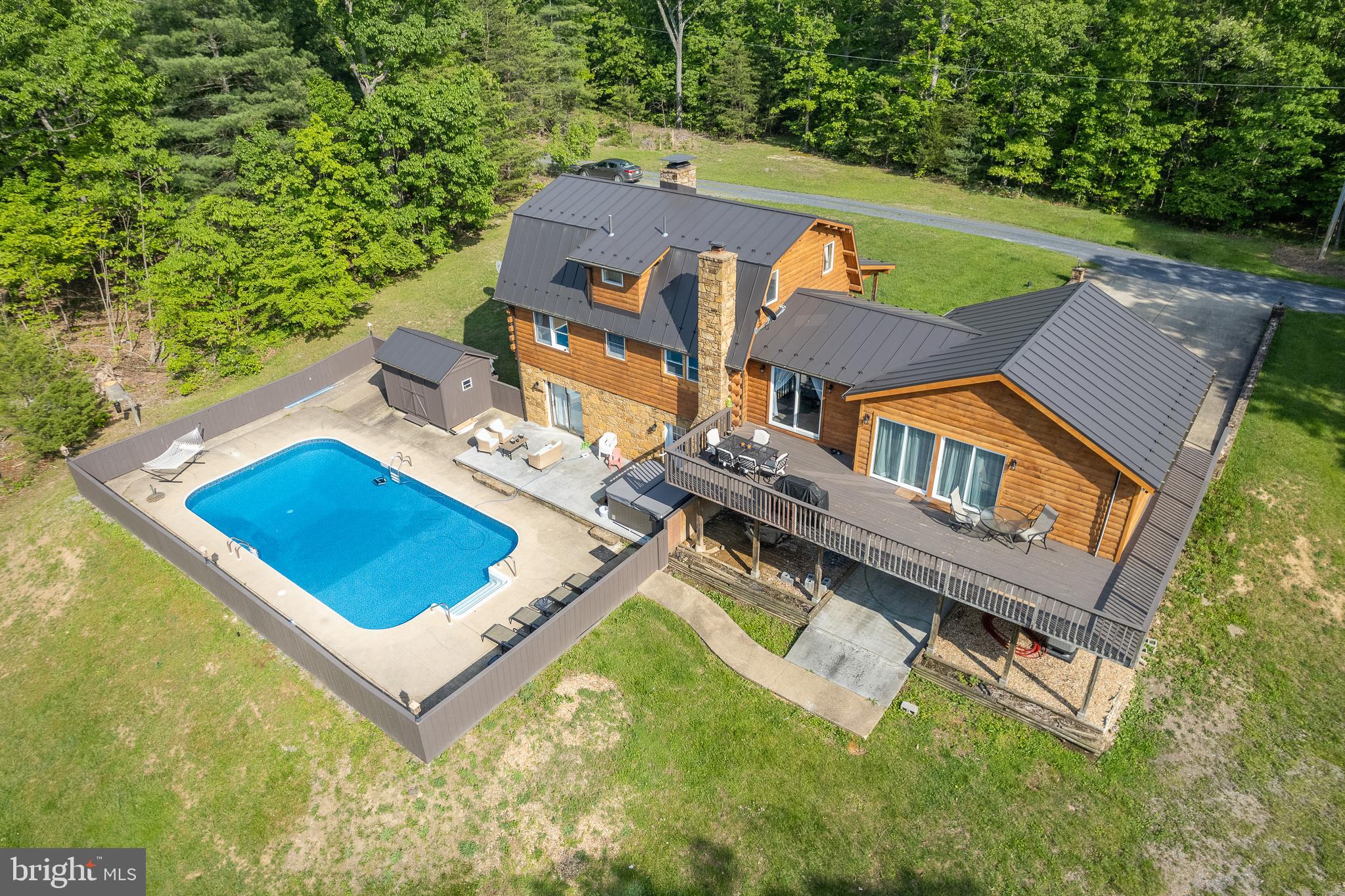 Don’t miss this rare opportunity to get the dream home of a lifetime. Primary Bedroom on the main level! You can have it all: a beautiful lake, a private pool, renovations, large detached 4 garage plus 1 car attached garage, extensive renovations, and almost everything is new.  Enjoy a lake view from every window on the back side of the house! The large, gorgeous heated pool is located in a tranquil setting, perfect for watching breathtaking sunsets over the lake water.  Enjoy swimming and fishing, and canoe in this amazing clean, and deep lake. This property sits on over 4.44 acres and includes a newly built very large dock on the water, making it a peaceful retreat ideal for relaxation or entertaining family and friends. The whole house has been completely renovated! So much is NEW! Newer Open Kitchen with a large island! All new floors throughout the entire home! All three bathrooms have been completely renovated with beautiful finishes.  Three bedrooms upstairs, but the main bedroom is huge and on the main level with an amazing fireplace.   The deck has also been newly renovated, providing additional outdoor enjoyment.  There is a huge detached 2280 sqft 4-car garage and an additional room plus a garage in the back of the house.    One of the garage bays has high ceilings and can store a 26 foot long RV.  All systems are new, the 3 New High Efficiency HVAC systems. All New Appliances! New Washer! New Dryer! 50 Year metal Roof! Culligan's top of the line water filtration system installed for perfect water.  Friendly Neighborhood! No HOA.  It does not get much better than this.  Don’t let this breathtaking gem get away,  10 minutes from I-81