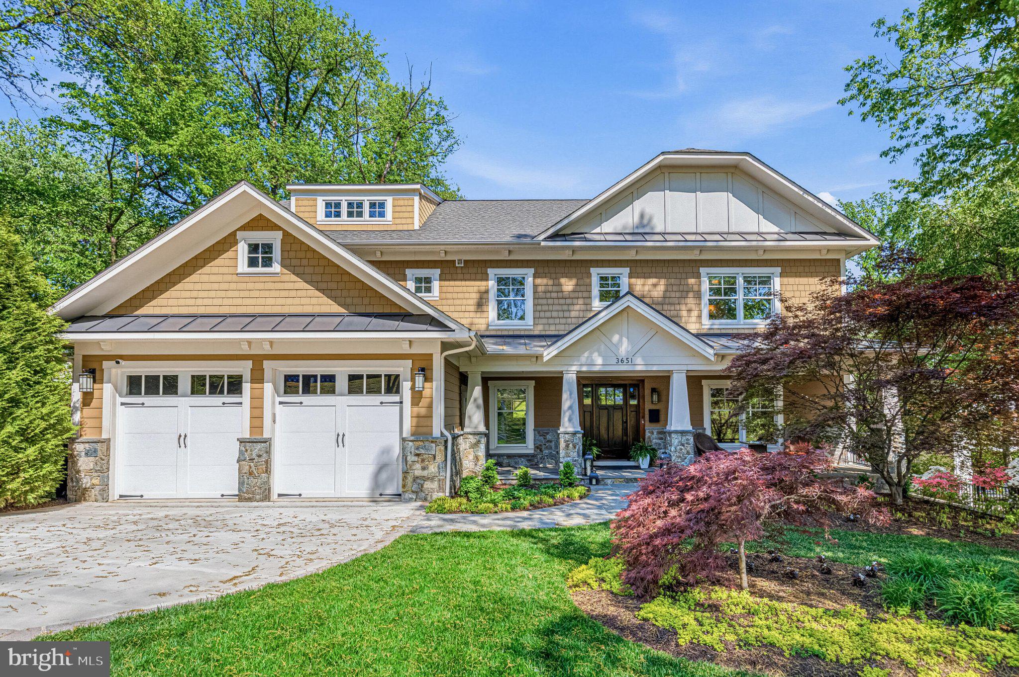 This exceptional home showcases a beautiful setting and intentional design throughout. Set on a 0.6-acre lot with a generous rear yard, the nearly 6,000-square-foot residence offers privacy, sophistication, and a highly functional flow for modern living. A gracious front porch opens to a spacious foyer, flanked by a formal living room or private home office with glass French doors. The heart of the home is a stunning, newly renovated kitchen that opens to the family room, which is ideal for both daily living and entertaining. With over $60,000 in upgrades, the chef’s kitchen features high-end Thermador and Viking appliances, including a six-burner range, a new dishwasher, and a new three-piece oven set, along with custom cabinetry, new quartz countertops, and a generous center island. The adjoining family room, anchored by a gas fireplace, offers a relaxed gathering space with views of the backyard.
A screened porch and adjacent deck extend the living space outdoors, while a well-appointed butler’s pantry with beverage refrigerator connects the kitchen to the formal dining room, perfect for hosting. The main level also includes a private guest suite with full bath, a powder room, generous storage, and a functional mudroom with direct access to the two-car garage.
Upstairs, four bedrooms, three full baths, and a convenient laundry room provide comfort and flexibility. The primary suite is a true retreat, featuring two walk-in closets, a sitting room with gas fireplace, a private walk-out deck, and a spa-inspired bath. One bedroom has an en-suite bath, while two others share a double-vanity bathroom. The walk-out lower level offers an expansive recreation room with wet bar which is ideal for entertaining, along with an exercise room, additional bedroom, full bath, and space for a wine room. French doors open to a covered patio, creating seamless indoor-outdoor flow.
The private backyard offers ample space for a pool, sport court, outdoor kitchen, or gardens. Ideally located near parks, shopping, dining, and with easy access to Washington, DC, this remarkable home offers the very best of Arlington living.