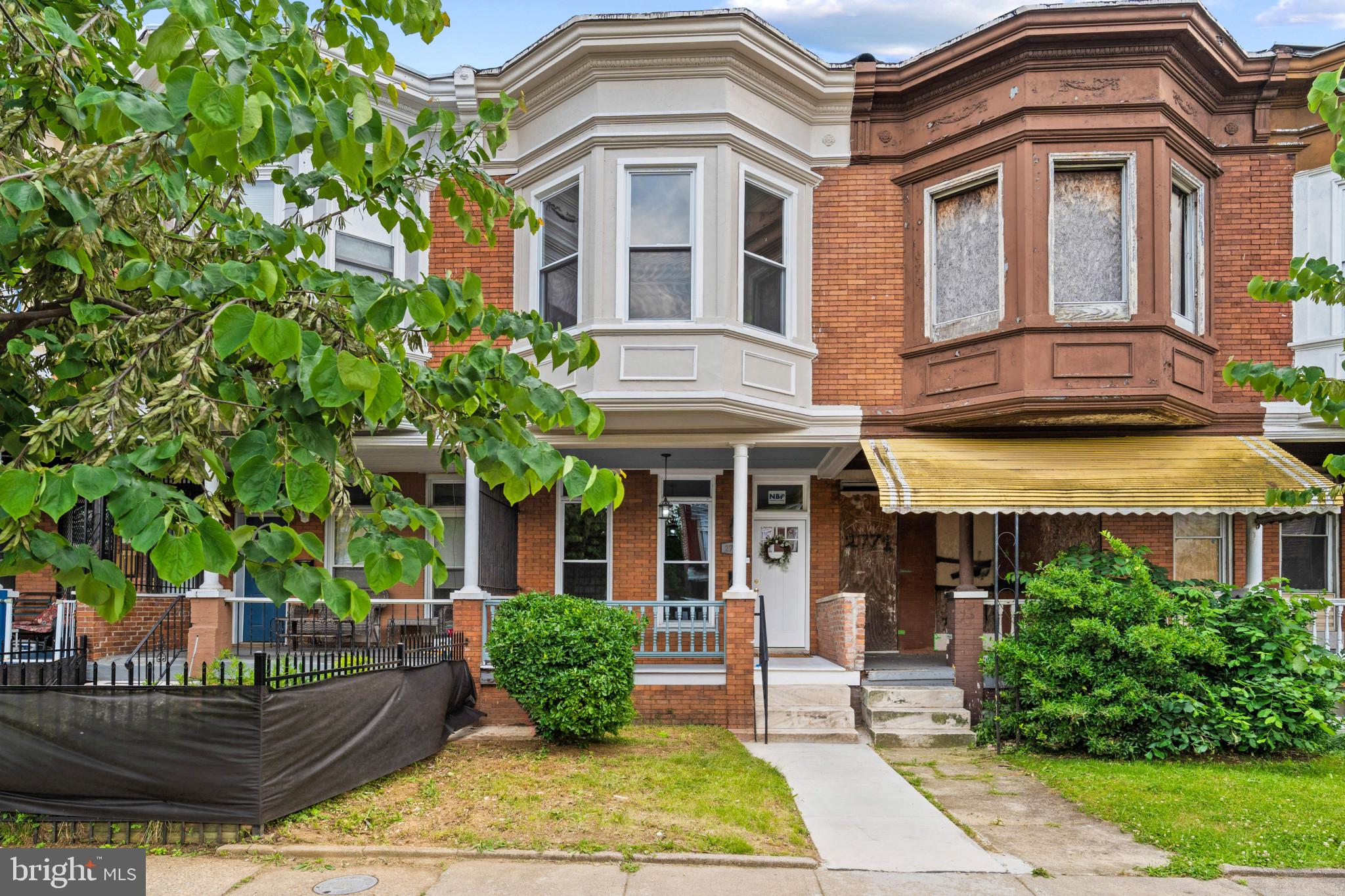 Absolutely beautiful, reimagined row house offering 5 bedrooms, 3.5 bathrooms, and 1,790 square feet in vibrant Coppin Heights/Ash-Co-Heights. // A charming front porch welcomes you inside the open-concept main level, featuring a versatile foyer space ideal for a sitting area or home office, a spacious living room, dining area, and a stunning eat-in kitchen with blue cabinetry, modern pendant lighting, a custom hexagonal backsplash, a center island with an L-shaped breakfast bar, generous counter space, a nearby powder room, and deck access. // Gleaming floors continue throughout the upper level, where you'll find a full bathroom, laundry room, and three bedrooms, including the spacious primary suite with bow windows and a spa-inspired ensuite bath. // The finished lower level expands the home's versatility with a recreation room, a fourth bedroom with a private full bathroom, and a fifth bedroom or flexible bonus room. The bonus room is currently used as a bedroom but does not meet all legal bedroom requirements, making it equally well-suited as a home office, den, guest room, or flex space. // Enjoy outdoor living on the covered deck overlooking the fully fenced backyard with a patio area. This is a must see!