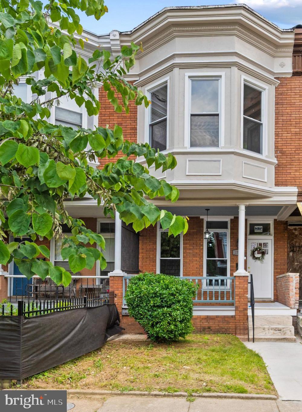 Absolutely beautiful, reimagined row house offering 5 bedrooms, 3.5 bathrooms, and 1,790 square feet in vibrant Coppin Heights/Ash-Co-Heights. // A charming front porch welcomes you inside the open-concept main level, featuring a versatile foyer space ideal for a sitting area or home office, a spacious living room, dining area, and a stunning eat-in kitchen with blue cabinetry, modern pendant lighting, a custom hexagonal backsplash, a center island with an L-shaped breakfast bar, generous counter space, a nearby powder room, and deck access. // Gleaming floors continue throughout the upper level, where you'll find a full bathroom, laundry room, and three bedrooms, including the spacious primary suite with bow windows and a spa-inspired ensuite bath. // The finished lower level expands the home's versatility with a recreation room, a fourth bedroom with a private full bathroom, and a fifth bedroom or flexible bonus room. The bonus room is currently used as a bedroom but does not meet all legal bedroom requirements, making it equally well-suited as a home office, den, guest room, or flex space. // Enjoy outdoor living on the covered deck overlooking the fully fenced backyard with a patio area. This is a must see!