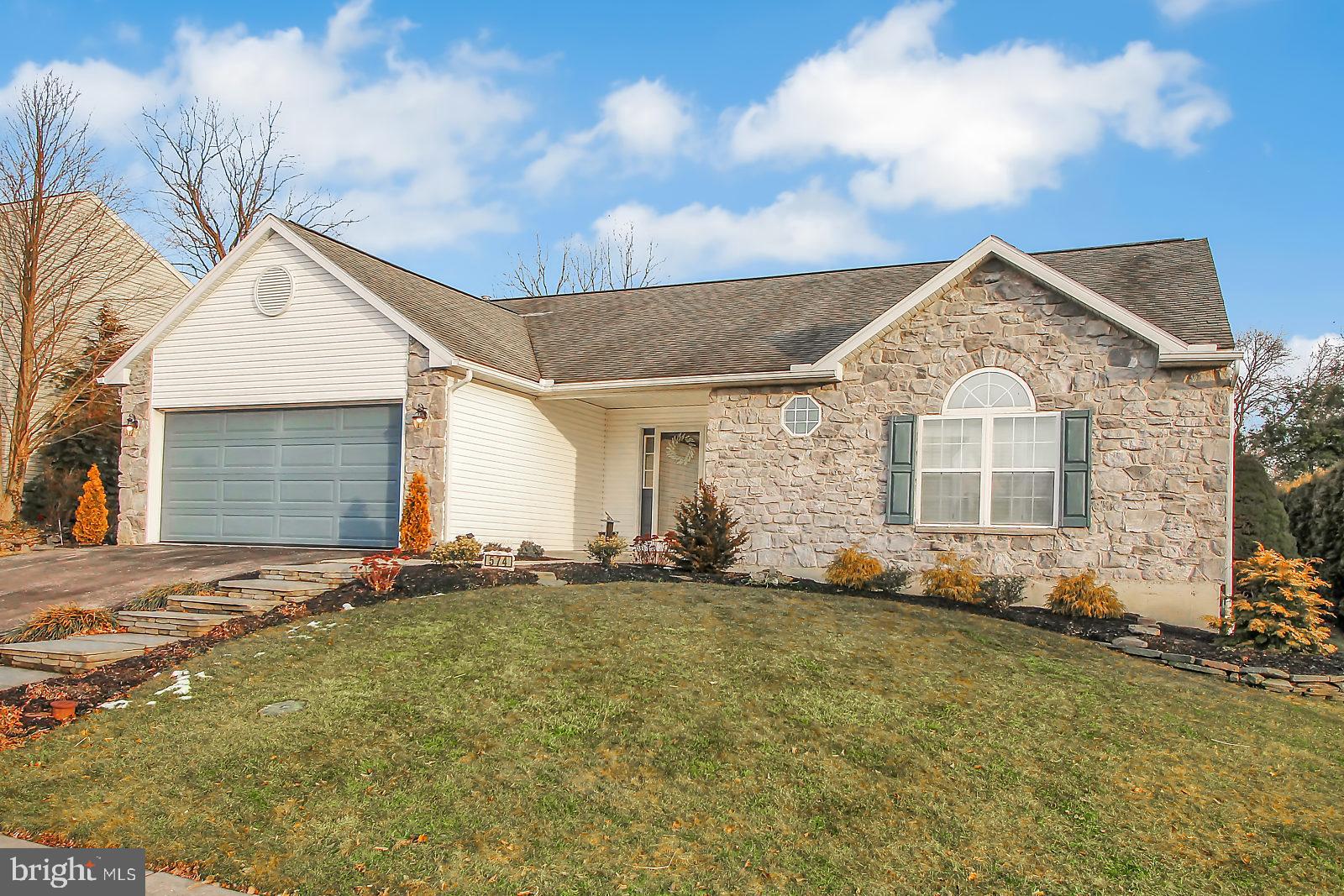 This stunning 3 bedroom, 2 bath ranch home is a must see!  You will fall in love with the open concept living/great room featuring vaulted ceilings, a gas fireplace, and immaculate maple hardwood floors. The kitchen is equally impressive with a breakfast bar, granite counters, tile backsplash, tiled floor, and dual fuel range.  The large master suite has a walk-in closet, custom wooden shutters, and a beautiful master bath with a tiled seated shower and a modern counter-height double bowl vanity. The other two bedrooms are on the opposite side of the home for privacy and they have their own full bath.  An added bonus is the gorgeous 23 x 12 insulated sunroom with tiled floor & tons of windows.  Also featured are central air, 2 car attached garage, huge basement, main floor laundry, and economical gas heat. Call today for your private showing, this one won't last.