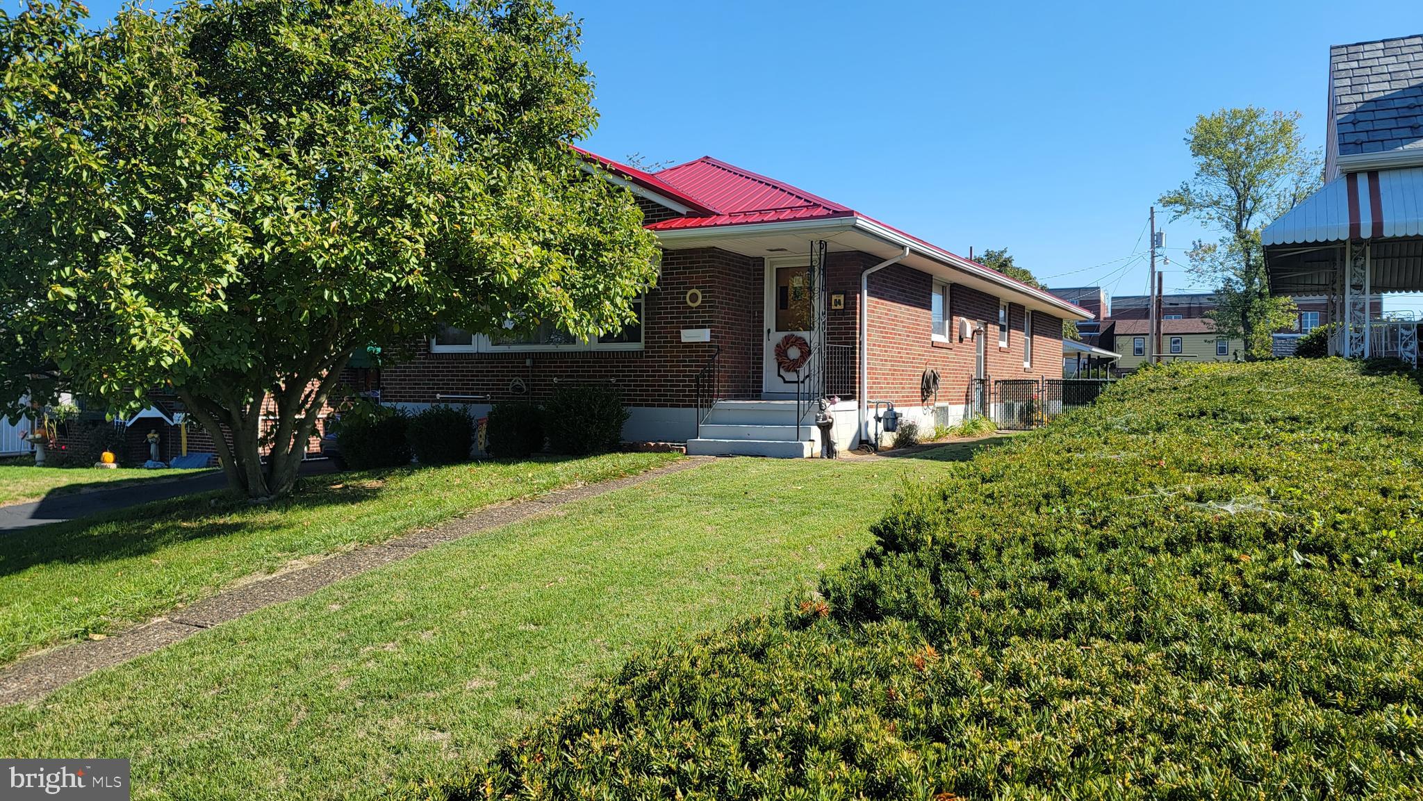 The ideal, one owner brick rancher is now available in a great neighborhood close to all the necessary services. Three bedrooms and 1 3/4 baths, the charming home is a unique open floor plan, plenty of windows to let in the light,  and has so many possibilities--all appearing to be cosmetic in nature. It has a new tin roof and a large, level lot. Main bath is definitely retro in style and would be so much fun decorating with today's touches. Second bath is located in the M. bedroom. Owner says that the home has hardwood floors throughout underneath original carpeting . Basement is large, unfinished, and open and could be made into a large family  room or more depending on your needs. So, get out your favorite home magazines, pull  up Pintrest on your computer and start dreaming of how very cool this lovely will be when you are finished!

Please note: there is a driveway on the left hand side of the house that is deeded to the house next door--it does not convey, however, with minimal work, a driveway to the carport can be created--there are a couple of options open (survey is available). Also, note the unique shed in the carport that was lovingly built by the family--this is a one owner home.