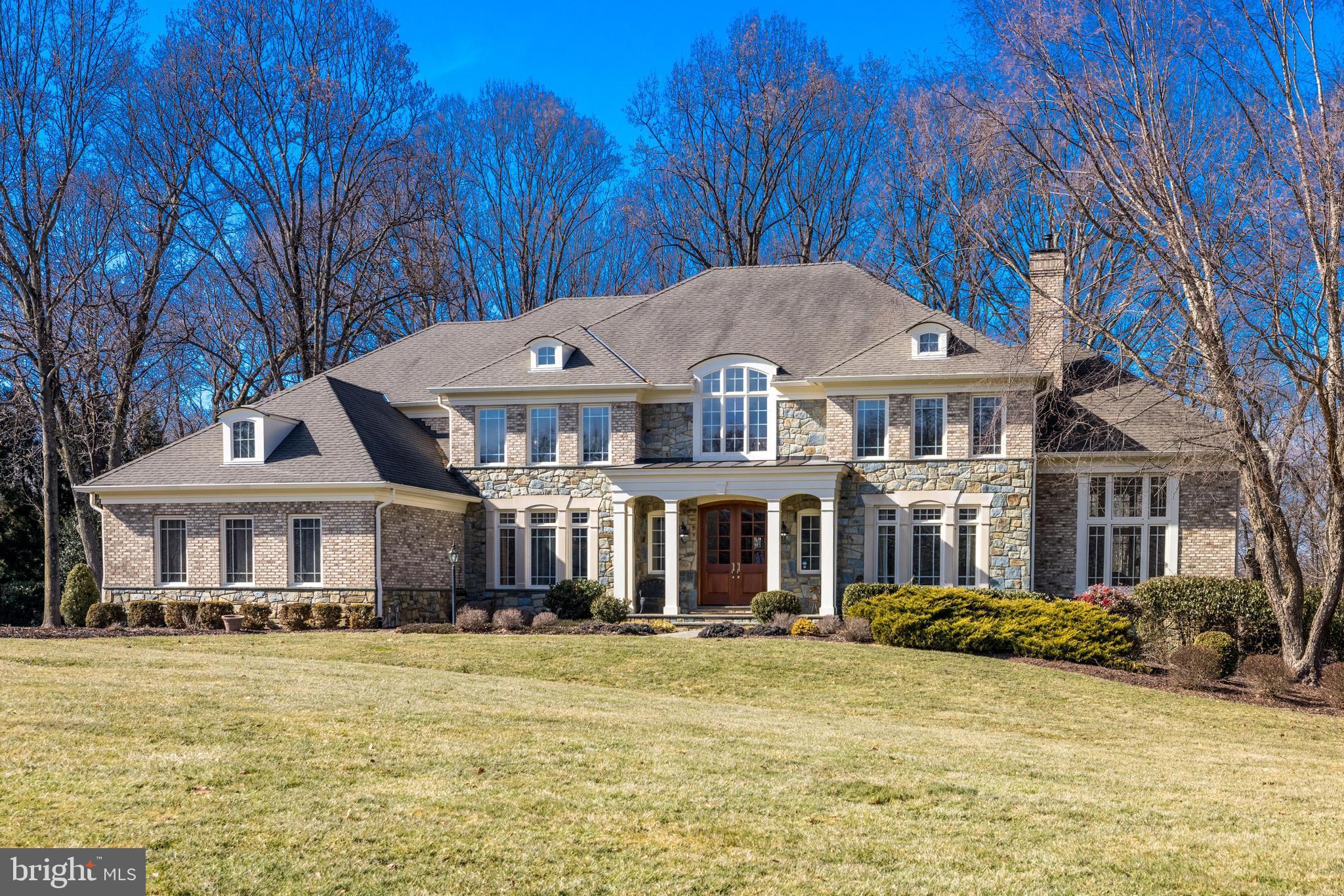 First timer ever on the market. This stunning Gullick-built Winthrop model offers six bedrooms, five full bathrooms and two half bathrooms, with thoughtful updates throughout. As the former model home for the community, it boasts many room upgrades, making it a truly exceptional property.   Sited on a serene 1.8-acre lot with exceptional curb appeal, this home features professional landscaping, front and back sprinkler systems, and a large private sport court, offering both beauty and functionality. The inviting residence also has a stone and brick elevation with a beautiful architectural stone surround.  The home is also on a cul-de-sac with the convenience of natural gas, public water, and public sewer.  It is conveniently located within the Langley HS, Cooper MS, and Forestville ES school pyramid, and provides easy access to Great Falls Village, Reston Town Center, and Tysons Corner, all of which offer premier shopping and dining options.  

Stepping through the brand-new striking mahogany double door, you are welcomed into a grand two-story foyer with a sweeping curved staircase. Hardwood flooring, ten-foot ceilings, wood doors, and elegant crown molding enhance the sophisticated atmosphere throughout the main level. A formal living room with a fireplace offers an inviting space for conversation. The dining room, illuminated by a beautiful chandelier, is ideal for hosting elegant dinners. A stunning conservatory with windows on three sides provides an additional room for an office, relaxation, or entertainment.   The library, with custom built-in shelving and a double-door entry, serves as a refined workspace.

The spacious family room features a custom gas fireplace, a wall-mounted television, and large windows overlooking the beautifully landscaped backyard. The gourmet kitchen is a chef’s dream, showcasing brand-new quartz countertops, extensive cabinetry, two sinks, and a butler’s pantry with a wine refrigerator. The oversized center island provides additional seating, while high-end luxury appliances, including a Dacor double wall oven, a Sub-Zero refrigerator, and a Viking Series 7 professional gas cooktop, elevate the space. A breakfast room offers the perfect setting for casual dining, and the adjacent sunroom, with new 18-inch by 18-inch tile floors, is bathed in natural light and provides expansive views of the backyard. An oversized deck extends from the home, offering an ideal space for outdoor gatherings.

A large side-entry three-car garage with high ceilings provides convenient access to the home. Just inside, a well-appointed mudroom includes a walk-in closet, a pantry, and a separate laundry room with a sink, adding to the home's functionality.

The upper level primary suite is a true sanctuary, featuring a sitting area, fireplace, wall mounted television, and two large walk-in closets. The completely renovated primary bathroom exudes spa-like luxury with a two-sink vanity, gorgeous tile work, a walk-in glass shower, and a separate soaking tub.  Additional bedrooms on this level include a second bedroom with a walk-in closet and an en-suite bathroom with a glass shower. The third and fourth bedrooms each have walk-in closets and share a beautifully renovated Jack and Jill bathroom with a glass shower. The fifth bedroom also includes a walk-in closet and a completely renovated private bathroom with a tub.

The lower level has been freshly painted and offers expansive spaces designed for entertainment and relaxation. A large open area includes a family room with fireplace and wall mounted television, game room, and bar.  Additional features include a media room and a gym, as well as a guest bedroom with a renovated bathroom. Several large storage areas provide ample space for organization.

Come see all that this truly exceptional home has to offer!