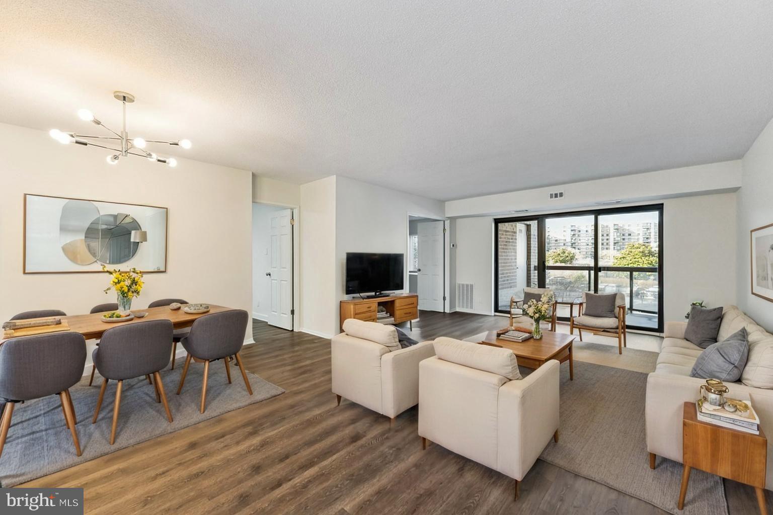 Located in the secure, gated 34-acre Rotonda pet-friendly community, this stunning home boasts fresh paint and newer luxury vinyl plank flooring throughout the entire unit.  Two surface parking spots convey + storage unit included! Plus, easy access to the elevators! Modern & Stylish Upgrades: - Updated bathrooms with new modern vanities, a stylish tiled master shower with a detachable shower hose, and glass shower doors. All new kitchen with brand new stainless steel appliances, including: *Quartz countertops *Electric cooktop *Dishwasher *Microwave oven *New white shaker 42" soft-close cabinets and drawers * in-unit stackable washer/dryer.  Newer HVAC (2021). Exceptional Community & Amenities:  2 surface parking spots -  Building 3 is ideally located near outdoor amenities: *Picturesque lakes & gazebo *Manicured walking trails *Gated dog park *Two playgrounds *Three sports courts *DIY car wash *Shaded picnic areas Unbeatable Location & Accessibility: Rotonda’s prime location is directly across from The Boro, featuring Whole Foods, a luxury theater, top-rated restaurants, and an authentic French bakery. It’s also on the Silver Line with two Metro stops and Kaiser Permanente within walking distance. Newly re-zoned school pyramid to Cooper MS and Langley HS! Resort-Style Amenities: - Indoor heated pool (open all year round!) & enormous outdoor pool connected to the domed Community Center - Library, study lounges, and business center - Gym, multipurpose room, and free Wi-Fi in the common areas -Ping pong, billiards, foosball, and saunas - Two unassigned parking spaces on surface lot - 1,600 unassigned spaces throughout the community. Don’t miss this incredible opportunity to live in one of the most sought-after gated communities with unbeatable amenities and location!