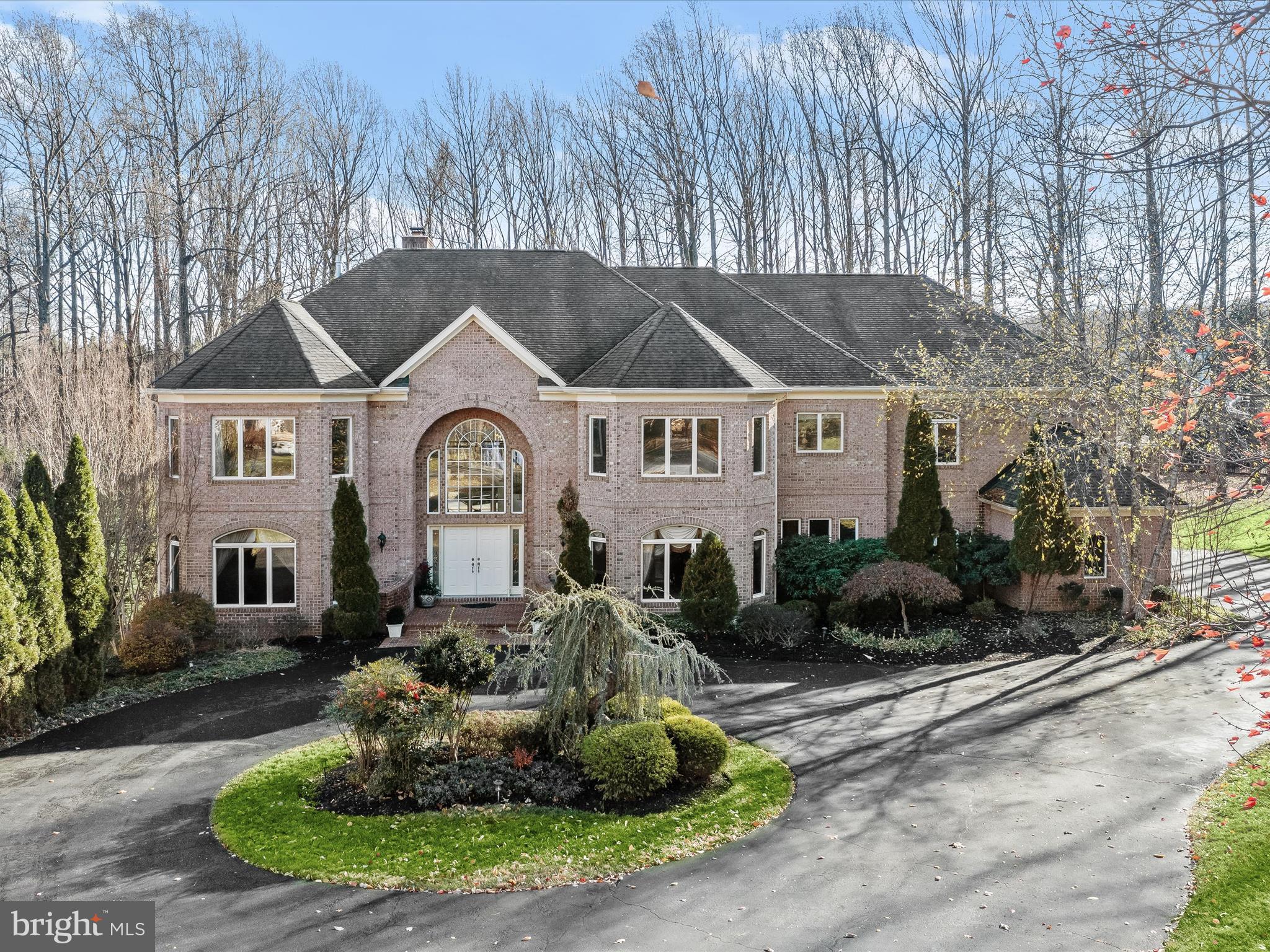 Presiding over a stunning private lot, this breathtaking all-brick Dale Thompson custom-
built estate home in the prestigious Pindall Woods community is immaculate, top to
bottom offering fresh, up to the minute finishes, and unmatched exterior amenities.
Discover the seamless blend and balance of interior and exterior living spaces that are
professionally designed and impeccably maintained. Entrance to the premium lot is
marked by a pair of Governors pillars, a circular drive, and an ornamental garden. A
dramatic brick porch and double entry doors welcome family and friends into 10,000
square feet of perfected interior living and entertaining spaces.

A seamless blend of sophistication, modern convenience, and daily retreat combine
with professionally landscaped grounds, a heated solarium building with remote ceiling
panels that open to the sun and sky on command, and a heated inground pool, setting
the stage for unparalleled daily activities and gatherings large and small. Artfully
designed stone patios, walkways and garden beds are accented with Crepe Myrtle,
Japanese Maple and White Birch trees and exterior lighting, while Arbor Vitae create
added drama and privacy. The rear oasis is accessible from a walk-out finished lower
level, with nearby patios and a gas fire pit. It is also layered with a wrap-around, low-
maintenance TREX deck, balcony and dining gazebo.
Inside, a grand, two-story foyer and curved staircase are sided by living and dining
formals that are defined by stately clustered architectural columns, crown molding, and
paired designer chandeliers. Pristine hardwood floors are a unifying design element
that unfold and travel throughout the main level. The gracious open-plan great room
opens onto a balcony and pergola, whilst the adjacent turret creates a charming
octagonal morning room with a dramatic vaulted ceiling and offers easy access to a
wrap-around deck and dining gazebo, providing the perfect setting for casual dining
alfresco or vibrant entertaining under the stars.
Create your favorite dish in a gourmet chef’s kitchen, outfitted with a walk-in pantry,
prep sink, Viking appliances and a Sub-Zero fridge. At center stage, a commanding
entertainers island and breakfast bar are encircled by fresh white cabinetry and
upgraded quartz countertops.
Lifestyle options are endless and include a private main level en-suite bedroom with a
full bath. Outfitted with a custom library built-in, this bedroom can also become a study
and offer a quiet retreat for work or relaxation. The main level is completed by a
generously sized laundry center with cabinetry and utility sink.

Upstairs, the primary suite is a private haven, boasting a high tray ceiling with cove
lighting, cozy gas fireplace, a tranquil sitting room with another library built-in, dual walk-
in closets, and an opulent en-suite bath with a spa-like vibe, jetted tub at center, and a
separate dressing vanity. Four additional en-suite bedrooms are each outfitted with
walk-in closets, library built-ins, and two beautifully appointed dual entry bathrooms.
The walkout lower-level is truly an entertainer’s paradise, featuring a recreation room
with a wet bar, a media room, billiards room, exercise room, hobby room and an
additional en-suite bedroom with a full bath. Outside, indulge in exceptional outdoor
living, from the pool solarium, stone patios and garden beds, to the tree house, and the
expansive deck with gazebo. This incredibly special property provides the ultimate in
lifestyle options, comfort, and retreat in one of the area's most coveted communities, all
near great schools shopping and entertainment. Come home and enjoy perfected living
and entertaining in Fulton, MD.