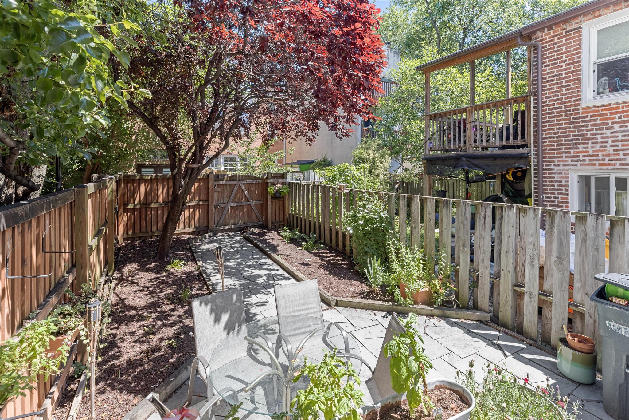 Your dream home awaits on a picturesque tree-lined street in the heart of historic Otterbein, where timeless charm meets vibrant city living. This beautifully updated three-bedroom, one-and-a-half-bath residence offers stunning city skyline views, a private rooftop deck, and a captivating courtyard-style backyard retreat.

Step inside to discover an open-concept main level enhanced by rich hardwood flooring and a modern neutral color palette. The inviting living room features a cozy wood burning fireplace and flows seamlessly into the sun-filled dining area, creating an ideal space for everyday living and entertaining. The thoughtfully designed kitchen showcases granite countertops, a decorative tile backsplash, 42-inch cabinetry, open shelving, and stainless steel appliances, including a Bosch dishwasher and gas range.

Just beyond the kitchen, the backyard serves as a private urban oasis. A flagstone-style paver walkway and patio create a charming, low-maintenance outdoor living space that perfectly complements the character of the Baltimore rowhome. Mature landscaping and a striking ornamental tree provide natural beauty, shade, and privacy, making this an ideal setting for relaxing or dining al fresco. Featuring a convenient main-floor powder room for guests and a full bath servicing the upper bedrooms, leaving plenty of room to enjoy the home's primary crown jewel: the private rooftop deck.

Ascending to the upper levels, a dramatic light-filled staircase serves as an architectural focal point. Warm wood treads are complemented by a contemporary black metal railing with geometric detailing, while custom floating shelves add both character and functionality. An expansive window and soaring ceiling fill the space with natural light, creating an open and airy atmosphere.

The first upper level offers a spacious primary bedroom, a generously sized second bedroom, and a beautifully renovated full bath featuring dual vanities and stylish tilt mirrors. Continue to the top level, where the third bedroom enjoys cathedral ceilings and skylights that flood the space with natural light, creating a peaceful retreat with added privacy. From this level, step outside to the spectacular rooftop sky deck, where sweeping views of the Baltimore skyline provide the perfect backdrop for morning coffee, evening cocktails, or entertaining under the stars.

The lower level offers excellent storage space and additional flexibility. The partially finished basement provides the ultimate flexible bonus space—perfect for a private home office, gym, or media room, keeping your three upper-level bedrooms completely open. The laundry area, complete with washer and dryer, is also located on this level.

Enjoy effortless city living in the heart of historic Otterbein! While this home does not feature a private pad, it boasts full, immediate eligibility for Baltimore’s highly coveted Area 8 Residential Parking Permit. Renowned as one of the most accessible and quietest parking zones in South Baltimore, Area 8 provides ample, stress-free street parking directly outside your door—free from the usual inner-city congestion.

Combining historic character, thoughtful updates, exceptional outdoor spaces, and an unbeatable Otterbein location, this home delivers the very best of city living.
