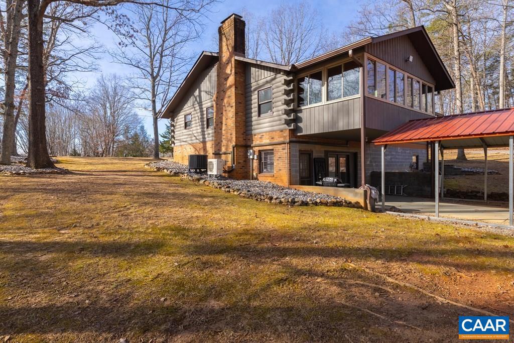 Discover the allure of this recently remodeled log house nestled on over 5 acres of land, adjoining the Featherfin Wildlife Management area. Meticulously refurbished, the property boasts stripped and caulked logs, new paint, flooring, countertops, and upgraded bathrooms featuring elegant granite finishes. The addition of high-speed fiber optic internet ensures modern connectivity, while the cozy sunroom offers captivating views of the surrounding landscape. With finished basement rooms, trails, and even a thrilling zip line, this property presents an exceptional blend of comfort and adventure. A must-see for those seeking a harmonious blend of rustic charm and contemporary living. Contact your agent for a comprehensive list of upgrades.