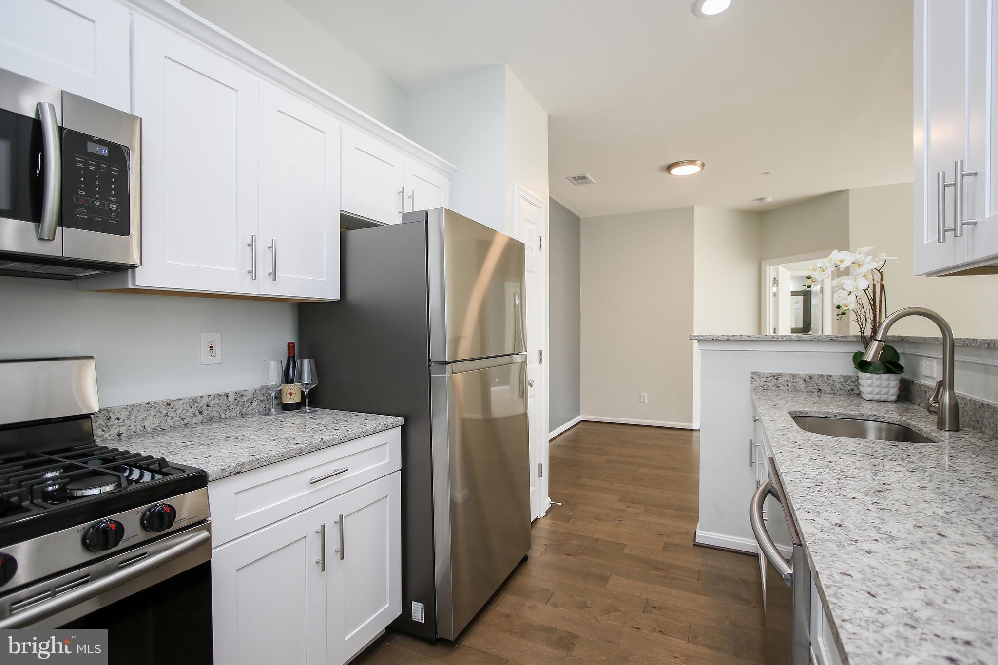 Gorgeous,Completely Renovated,Light-Filled,Spacious Condo in Russett!*Wide-Plank Wood Floors*Modern Shaker Cabinets w Moon White Granite*Stainless Samsung Appliances*Recessed Lights*Upgraded Bathrooms w 12x24 Tile,Granite,New Cabinetry & More*Patio w Private Views from Back*Fireplace*All of the Russett Amenities*Shopping*295/198/32/95 Mins Away!FHA Approved.*Offers presented Mon 1/26 6pm**
