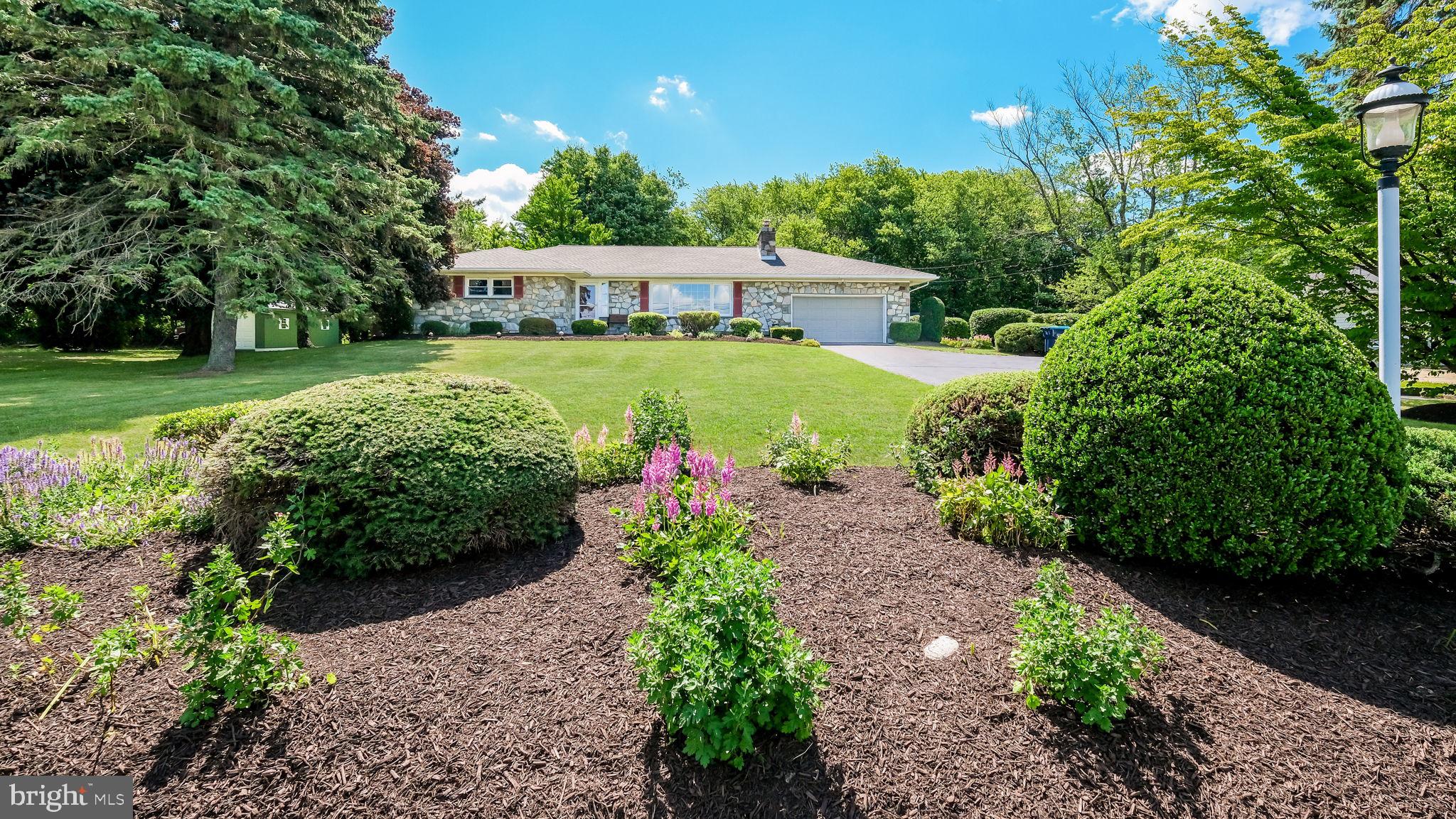 Beautiful sprawling 3-4  BR, 2 full bath stone front Rancher Features formal entry that opens into the spacious Living room with large picture window that invites in the sun & full stone wood burning fireplace, hardwood floors under wall-to-wall carpet that continues into the Dining room with chair rail & large casement  bow window. Dining rm opens into Kitchen with oak cabinetry, double sink, electric cooktop with overhead microwave, double wall oven & large island/breakfast bar with prep sink . The Kitchen opens to the breakfast room with peninsula island. The eating room addition features a cathedral ceiling & glass doors leading to 27 x 24 rear deck overlooking private rear yard. Three large bedrooms on the 1st floor including Primary BR w/ full bath with walk-in shower. and hall bath with ceramic tile floor and tub shower combination with tile surround. Wall to wall carpet over hardwood floors in all the bedrooms and hallway. Full Basement with large finished game room/dry bar with seating for 8 &  full walk up to grade steps to the backyard. There is also area a 2nd finished area with 14x14 ceramic tile floors that was used a a 4th bedroom, There is an additional unfinished area for storage. 2-car attached garage with access to the Kitchen and 1st floor Laundry rm.