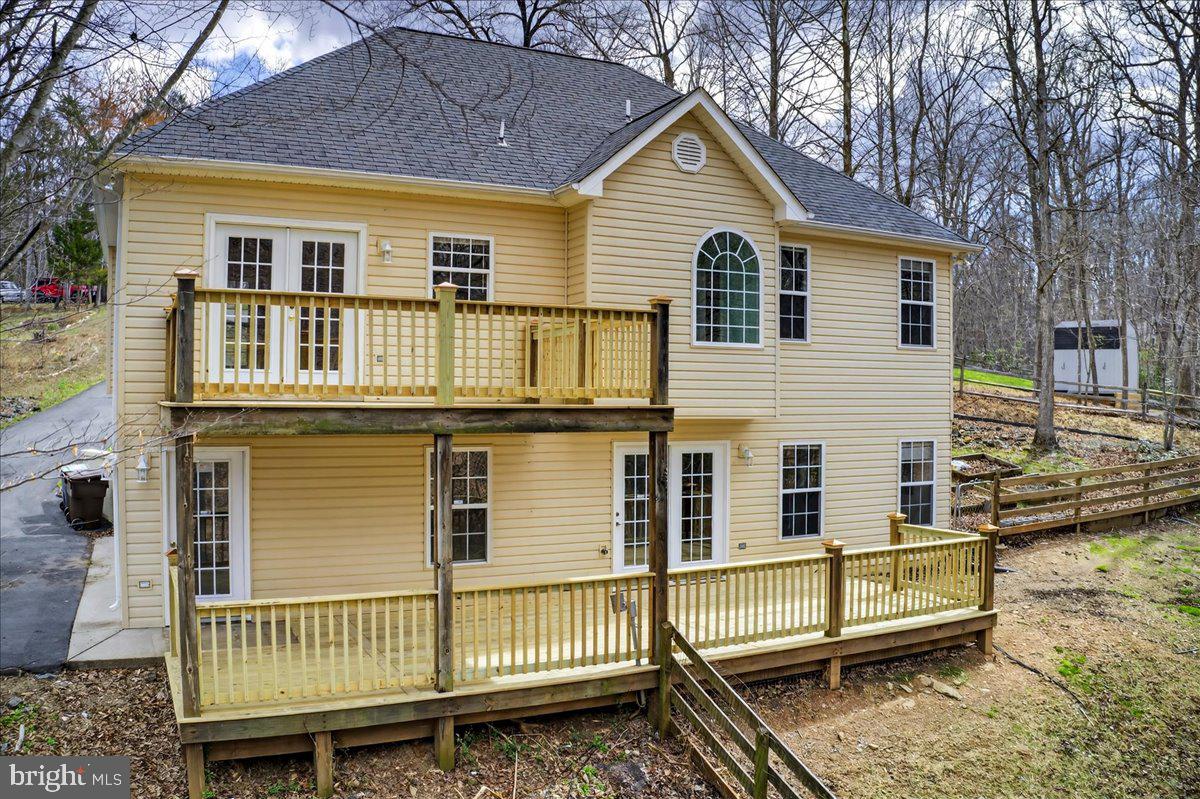 Tucked away on a quiet cul-de-sac in the Cherokee neighborhood of Lake Monticello, this beautifully updated 4-bedroom, 3-bath home offers the perfect blend of privacy, comfort, and convenience. Located outside the gated entrance, you'll still enjoy access to all of Lake Monticello's amenities, including beaches, golf, pool, clubhouse, dining, playgrounds, and more.

Surrounded by full trees and overlooking a creek, this property offers a setting that's hard to find. Relax on the new upper deck, unwind around the fire pit, tend to the raised garden beds, or enjoy the fenced backyard with plenty of space for kids and pets. The new oversized lower deck is already equipped with a hot tub hookup, making it easy to create your own backyard retreat.

Inside, the bright, open main level features vaulted ceilings, hardwood floors, and a stunning stone gas fireplace. The kitchen offers stainless steel appliances, a new dishwasher, updated backsplash, and a functional layout that flows seamlessly into the dining area and upper deck, perfect for entertaining. The spacious primary suite includes a soaking tub with wooded views, a walk-in closet, and a wall-mounted TV that conveys.

The finished walk-out basement features new LVP flooring, a fourth bedroom, third full bathroom, and flexible living space ideal for a recreation room, home office, gym, or guest suite.
Recent seller improvements include a freshly painted garage, professionally cleaned garage floor, and extensive outdoor cleanup, making this home shine inside and out.

Other recent property updates include a new HVAC system (2024) and new water heater (2023). The outdoor shed has power, great for extra storage. Complete with an oversized two-car garage and generous paved parking, this move-in ready home offers the space, setting, and lifestyle you've been searching for.