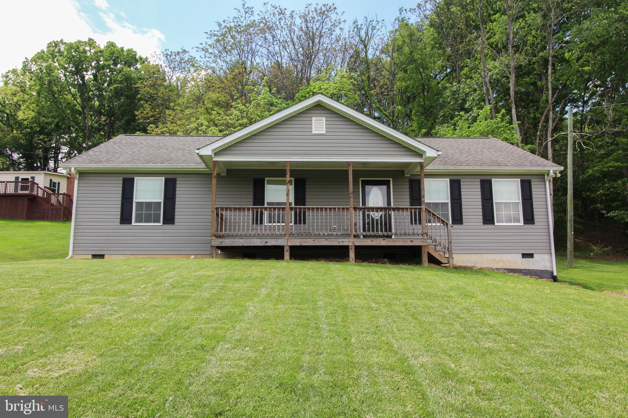 They say "Home is where the story begins". Let your story begin in this lovely home on 1 acre.  Come enjoy this spacious open floor plan, where you won't feel closed in.  The kitchen has stainless steel appliances, double sinks, wood cabinets and a center island with extra cabinet space and a place for chairs so you are able to sip your morning coffee informally. The primary suite enjoys a walk-in shower, as well as, a large walk-in closet along with an additional large closet. The two additional bedrooms will more than accommodate your family or friends.  There is a back deck where you can enjoy mother nature and a covered front porch that you can spend time in a rocking chair watching the beauty that surrounds you, including a pond across the street.  Call today to schedule an appointment to see this sweet home.