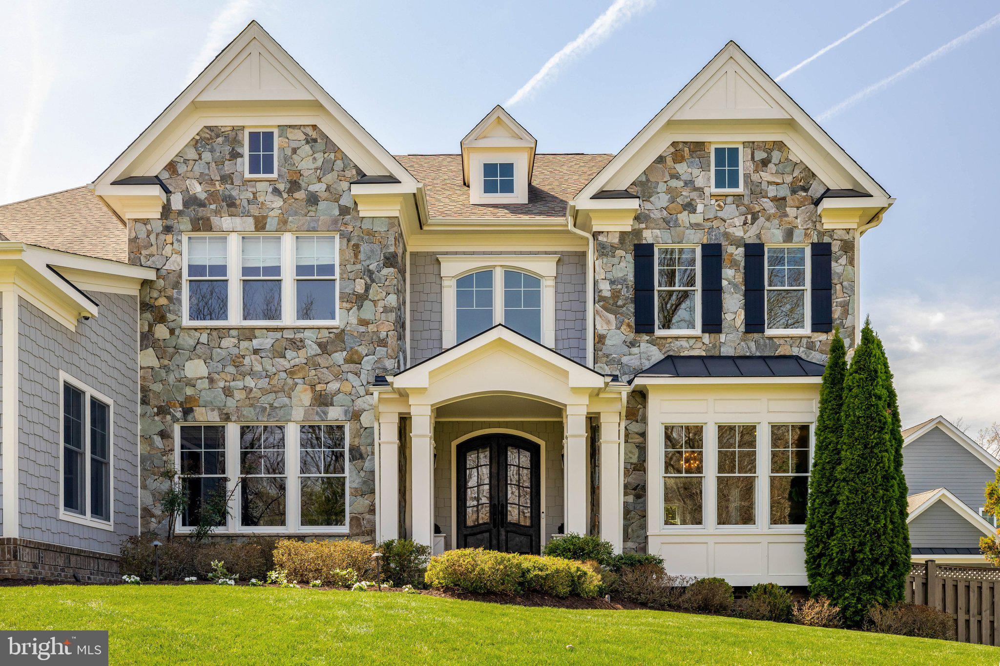 Since 2015, the owners of this Sekas-built Fairfax County luxury home have invested consistently in making 9115 Tetterton Ave the finest version of itself. No builder-grade finishes, no punch-list headaches. Just a home where every detail has been curated, tested, and refined. This is turnkey luxury at its truest.

The first floor sets the tone immediately. Formal living and dining rooms provide an elevated yet livable backdrop for everything from holiday gatherings to intimate dinner parties. Custom curtain rods and window treatments throughout add a layer of polish new builds simply don't come with. The chef's kitchen is anchored by a professional Viking Range and appointed with a wet bar, walk-in pantry, and open sightlines into the family room, the kind of layout that makes hosting feel natural. A dedicated main-level home office keeps professional life properly separated without sacrificing a bedroom.

Six bedrooms and five and a half baths make this one of Northern Virginia's most versatile luxury homes for families and multigenerational living. The second floor features four bedrooms, three full baths, and custom California Closets throughout. The primary suite offers his-and-hers walk-in closets, a separate linen closet, and a spa-caliber bath with soaking tub, separate shower, and multiple vanities.

The lower level goes well beyond a bonus space. A private guest suite with full bath sits alongside a kids' rec room, home gym, generous storage room, wine storage, and a custom golf simulator room. A finished lower level that takes years and real investment to create, already done here. The loft level adds a full bedroom and bath that works equally well as a home office or creative retreat.
Arrival is equally seamless. A side-load three-car garage with custom storage leads directly into a California Closets mudroom, because a home this considered shouldn't make you fight your own entryway.
Built for Peace of Mind

A whole-house generator, state-of-the-art security system, Trex deck, professional landscape lighting, and multi-zone irrigation round out a home whose infrastructure is as impressive as its aesthetics.

Minutes from Tysons Corner, with easy access to Metro, the Dulles Toll Road, Reston, and Dulles Airport. Wolf Trap National Park for the Performing Arts is just down the road. Served by Westbriar Elementary, Kilmer Middle School, and Marshall High School, among the most highly rated schools in Fairfax County and all of Northern Virginia.

New builds make you imagine the life you could have. This home delivers it.