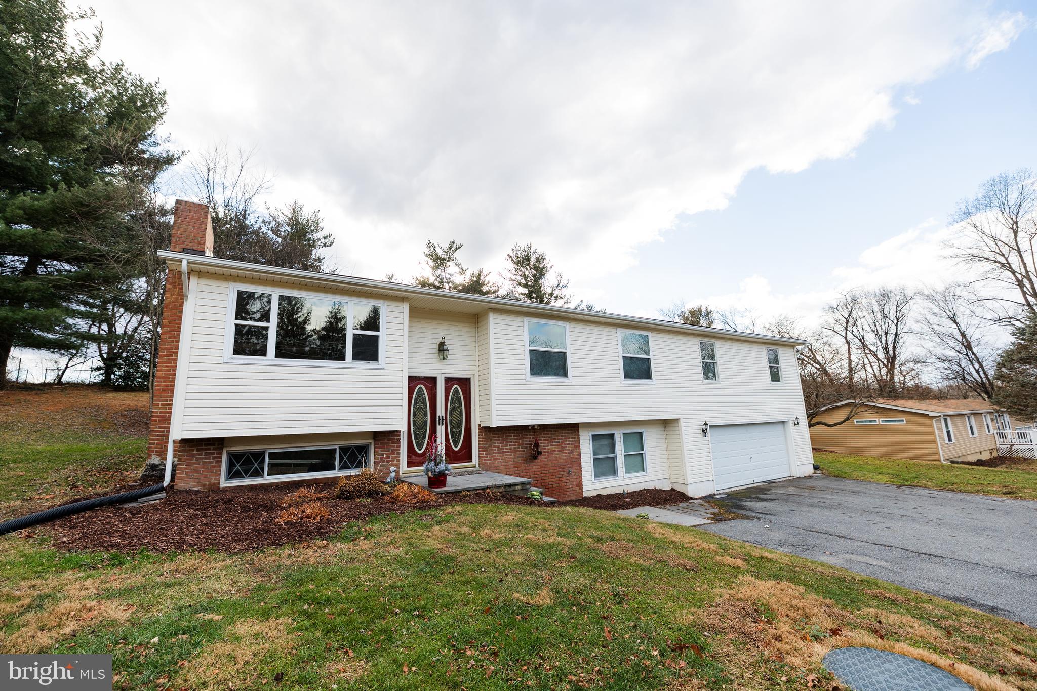 This motivated seller has adjusted this home to SELL. Discover the perfect blend of comfort and functionality in this beautifully renovated 4 bedroom, 3 bath, split foyer home, set on a generous 0.49-acre lot, in highly desirable New Market.  Built in 1969, this residence boasts a timeless brick and vinyl siding exterior, while the fully updated interior offers modern comfort with classic charm. The kitchen has been completely redone and flows seamlessly into the main living area, which features an inviting brick fireplace, perfect for creating warm memories on chilly evenings and making it ideal for everyday living and entertaining. A rare oversized primary suite located above the two-car garage, complete with a private en-suite bath and extensive closet space offer a personal retreat. The spacious layout includes a fully finished basement that offers endless possibilities-whether you envision a cozy family room, a home office, or a recreational space, the choice is yours!   With an attached garage that accommodates two vehicles and additional driveway space for six, parking will never be a concern. Enjoy the privacy and space of a generous lot in an established neighborhood, all while being conveniently located near commuter routes, shopping and dining.  Recent updates provide peace of mind, including a steel liner in the brick fireplace, HVAC replacement in 2022, well pump replaced in 2024 and a water heater replaced approximately two years ago. This move-in ready home has been freshly painted, and floors redone. With no HOA fees or community restrictions, you have the freedom to personalize your space as you see fit. Make this your home today!