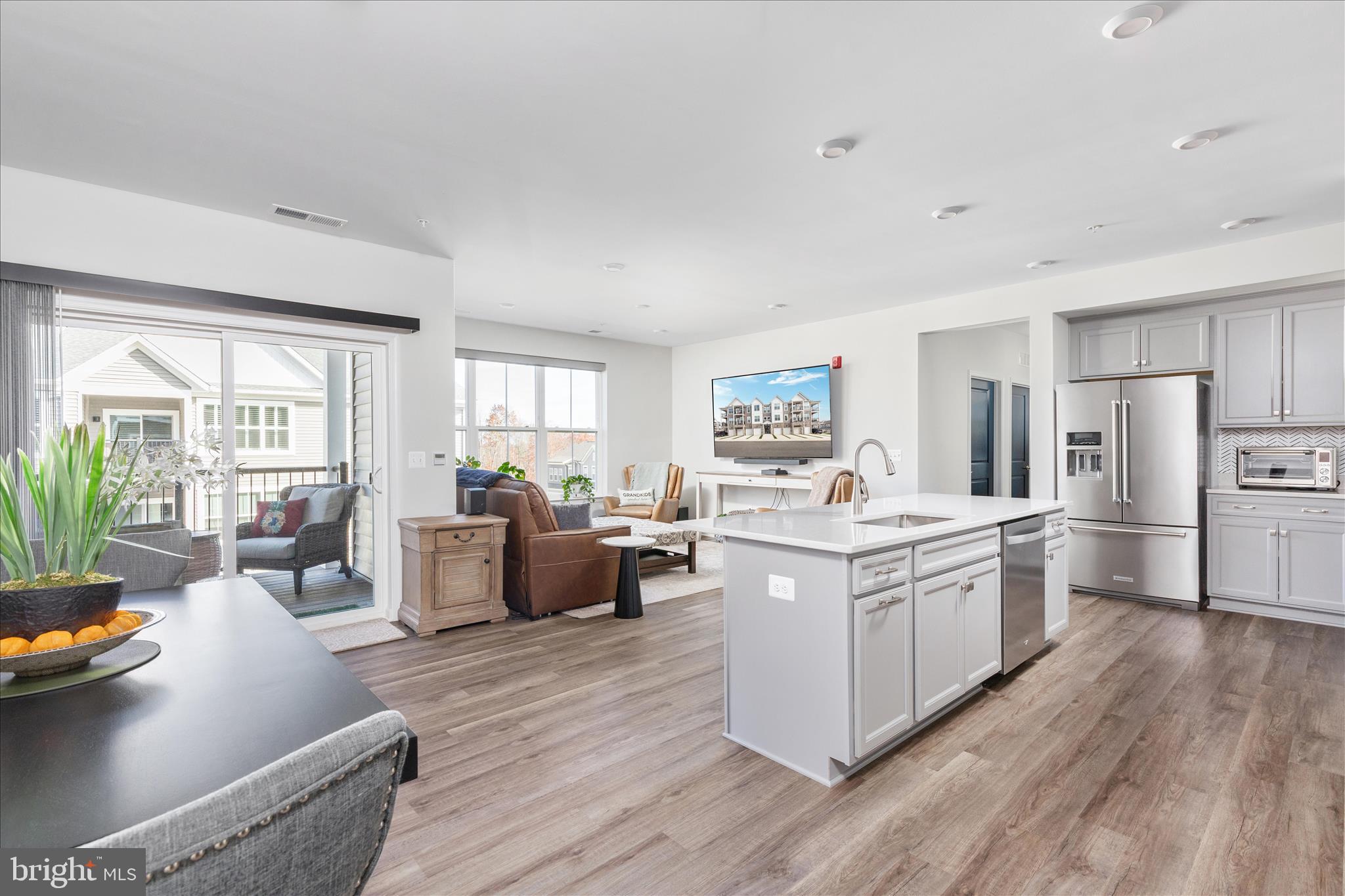 **PRICE IMPROVEMENT! NOW OFFERED AT $438,500. EXCEPTIONAL VALUE AND MOVE-IN READY FOR NEW OWNERS! This home is priced for a quick sale, making this move-in-ready gem an incredible opportunity.** Welcome to this stunning new one-level active adult condo in the premier Cascades at Embrey Mill community where comfort meets style. Step into a spacious foyer with an elegant tray ceiling and an open floor plan featuring luxury vinyl plank floors and designer finishes. Welcome to this stunning new one-level active adult condo in the premier Cascades at Embrey Mill community  where comfort meets style. Step into a spacious foyer with an elegant tray ceiling and an open floor plan featuring luxury vinyl plank floors and designer finishes. The chef-inspired kitchen impresses with a large island with bar seating, quartz countertops, custom backsplash, stainless steel KitchenAid appliances, modern gray cabinetry with pull-out shelves, and a generous walk-in pantry. The kitchen opens seamlessly to the dining area and bright, inviting living room perfect for entertaining or relaxing. A versatile built-in office with custom cabinetry offers the ideal work-from-home space. The laundry room includes a brand-new washer and dryer for added convenience. Retreat to the luxurious owner’s suite with a spacious walk-in closet and an elegant bath featuring dual quartz vanity, a frameless glass shower, private water closet, and an upgraded tile package. Two additional bedrooms and a full hall bath provide flexible options for guests or hobbies. Enjoy beautiful sunsets and tree views from your private balcony. Additional highlights include custom remote-controlled blinds, a one-car garage, extra storage, and shared elevator access. This home also features smart-home technology including programmable thermostat, keypad entry, CAT6 wiring and energy-efficient construction for modern living. Residents of Cascades enjoy resort-style amenities: clubhouse, pool, fitness & yoga studio, patio with fire pit & grills, pickleball and bocce courts, and more. Do not miss your chance to own this exceptional home. Schedule your showing today!