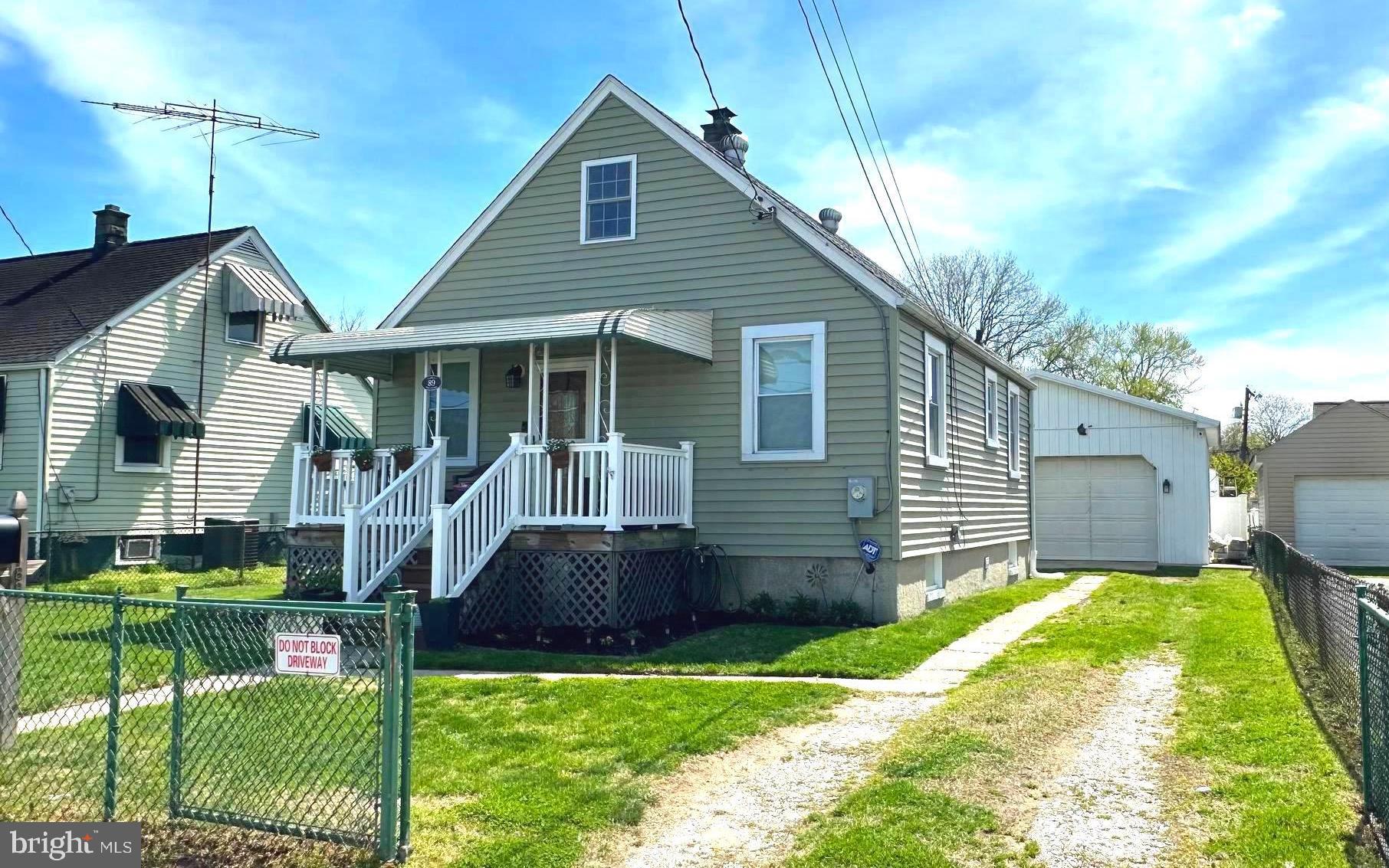 Charming, move-in ready Cape Cod offering low-maintenance living and great potential! Step into a spacious and bright living room that welcomes you home, featuring updated flooring throughout and a comfortable, inviting feel. The main level includes two well-sized bedrooms and a beautifully updated full bath. Enjoy the convenience of an updated kitchen with ample cabinetry and space for a table—perfect for everyday meals. A covered front porch adds even more charm and a perfect spot to relax. A pull-down attic provides easy access for storage and offers an excellent opportunity to be finished or renovated for additional living space. The unfinished basement provides excellent flexibility and is currently being used as additional living space—ideal for a rec room, home gym, or hobby area. Step outside to a partially fenced backyard with low-maintenance vinyl privacy fencing, along with a covered space perfect for outdoor dining and grilling. A standout feature of this property is the oversized two-car garage—perfect not only for parking, but also as an incredible entertaining space. With garage doors opening to both the driveway and backyard, plus a convenient half bath and mini-split system for year-round comfort, it’s ideal for gatherings, hobbies, or game days. This home offers the perfect blend of indoor comfort and outdoor enjoyment. This home offers the perfect combination of comfort, functionality, and future potential.