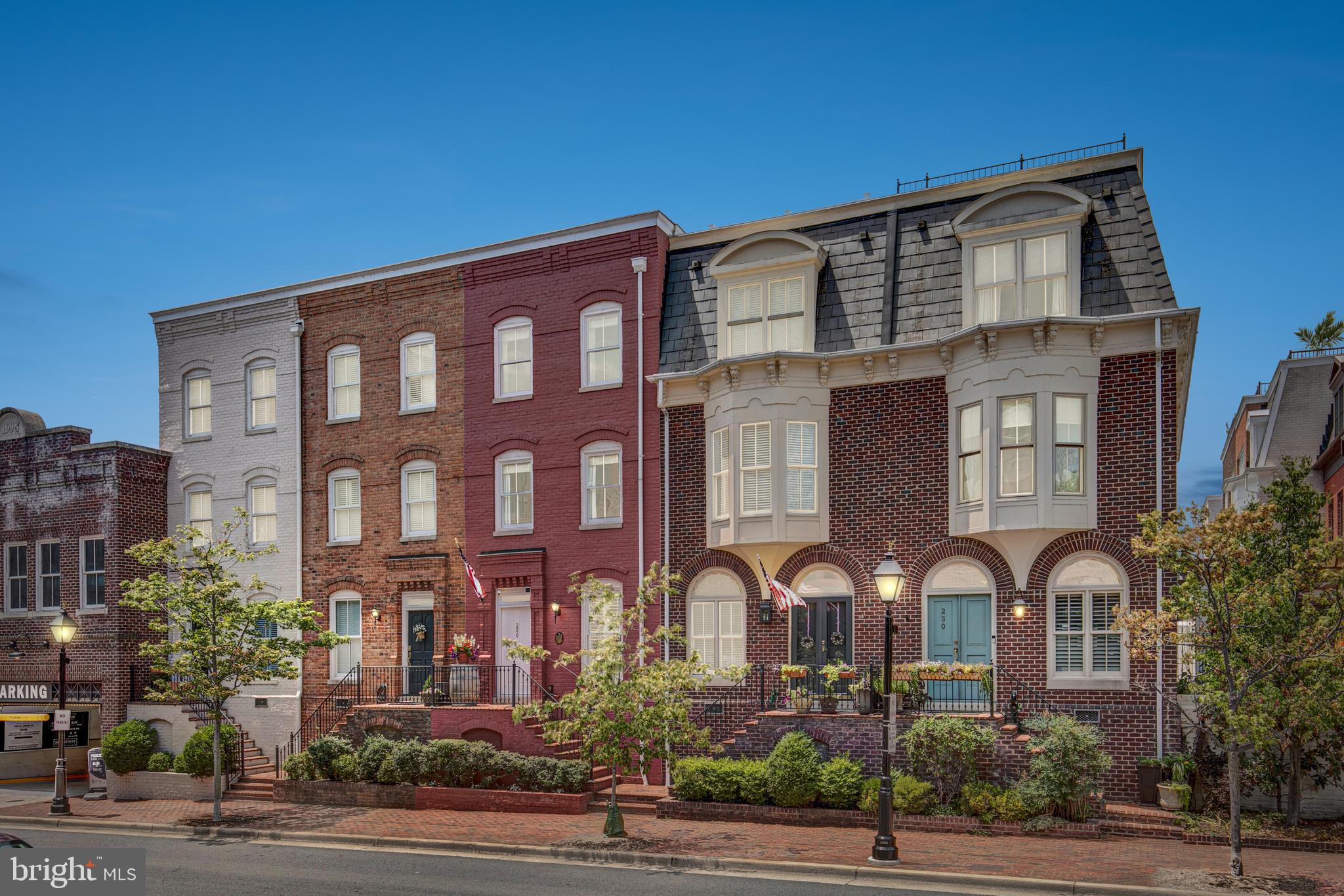 Nestled in the prestigious Queens Row, this all-brick townhome boasts three bright and open levels of living space, perfectly blending classic colonial elegance with modern comfort. The home features beautiful oak hardwood floors throughout, extensive crown molding, wainscoting, and soaring nine-foot and eleven-foot ceilings. Two gas fireplaces add warmth and charm, while the built-in cabinetry and large room sizes provide both functionality and a touch of luxury. Each of the three bedrooms comes with a full bath, ensuring privacy and convenience. The home is further enhanced by a large, sunny rear bay window, recently replaced custom windows, two oversized skylights, and two assigned parking spaces in a prime parking lot directly behind the home.

Upon entering, you are greeted by an ample walkway with a wood staircase that exemplifies elegant colonial design. The kitchen features white cabinetry, granite counters, glass french doors, recessed lighting, and gas cooking. Adjacent to the kitchen, the breakfast room is adorned with crown molding and a large window with shutters overlooking Union Street. The formal dining room is a masterpiece with hardwood floors, molding throughout, and a newly built-in wall-to-wall china display with wooden countertops, a wine chiller, and LED lighting, adding elegance and sophistication to the space. The living room invites relaxation with a gas fireplace, hardwood floors, built-ins, recessed lighting, and a four-section French door with a transom window opening to the slate patio and fenced rear yard.

The primary suite is a true retreat, offering a wall of closets plus a walk-in closet, hardwood floors, 11-foot ceilings, a second gas fireplace, recessed lighting, and a large bay window that bathes the room in morning sun. The primary bath has been completely remodeled with newer cabinetry, marble flooring and walls, dual vanity sinks, designer lighting, and an oversized shower with floor-to-ceiling rectangular tiles and a bench. The second bedroom also features hardwood floors, a double closet, and two windows offering afternoon eastern sun, along with its own spacious bathroom. The sunny upper staircase, illuminated by one of two skylights, leads to the top level, where the third bedroom and its full bath await.

The upper level also includes a versatile office/den and a laundry room with extended storage. Roof access provides stunning views of Old Town and the river. The home is equipped with a 3-zoned gas furnace and a gas water heater, with the HVAC replaced in 2021 and the water heater in 2017. A motorized awning off the living area and over the flagstone patio is ideal for al fresco dining. Additionally, TVs in the kitchen and living room, as well as the living area surround system, convey with the home.

Located in the heart of Old Town Alexandria, this gorgeous home is steps away from Founders Park and the Potomac River. Enjoy the extensive dining options nearby, from formal restaurants to casual eateries. Take the trolley to explore all of King Street and Old Town, or spend an evening on a riverboat. The walkways and bike trails along the river are seconds away, offering ample opportunities for outdoor activities. Conveniently situated, the home is just a block away from the water taxi to Nationals games and Georgetown, less than two blocks from the restaurants on King Street, and within a mile of two metro stations. The area also boasts bike routes within three blocks, a secure bike room, and is within a half-mile of multiple grocery stores, a post office, a library, and a CVS. Experience the charm and convenience of living in one of Alexandria’s most sought-after locations.