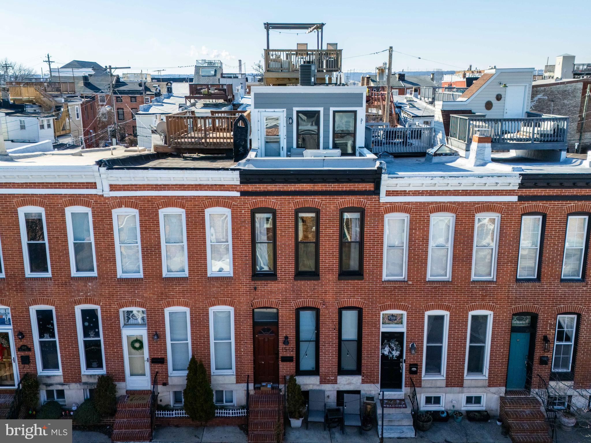 Steps from Riverside Park on Henry Street’s widest and most desirable block, this beautifully renovated approx. 2,700 square foot, 4 bedroom, 4.5 bathroom, 4-level home offers a rare blend of space, style, and breathtaking city views.  Step inside to an expansive main level featuring a bright and open living room that flows seamlessly into a dedicated dining area—perfect for gatherings and entertaining. Beyond the dining room, the gourmet kitchen impresses with an oversized island, quartz countertops, stainless appliances, and a generous pantry for ample storage. A conveniently located half bath completes this level.  Upstairs, the second floor offers two spacious bedroom suites, each with ample closet space and private bathrooms. The third level has the luxurious primary suite, complete with a large walk-in closet, a spa-like bathroom, and a private balcony—perfect for morning coffee with an amazing city skyline and water views. This level also features an open flex space, currently used as a home office, which leads to the  two-tier rooftop deck that has breathtaking panoramic views. One of the best views in the neighborhood. The finished basement adds even more versatility, offering an additional bedroom and full bath, ideal for guests, a home office, and/or a home gym. Outside, the rear patio provides the perfect space for a garden, grill, or a private retreat for pets. Conveniently located near Riverside Park, shops, top-rated restaurants, and with easy access to I-95, this home is a must-see. Schedule your tour today and experience city living at its finest!